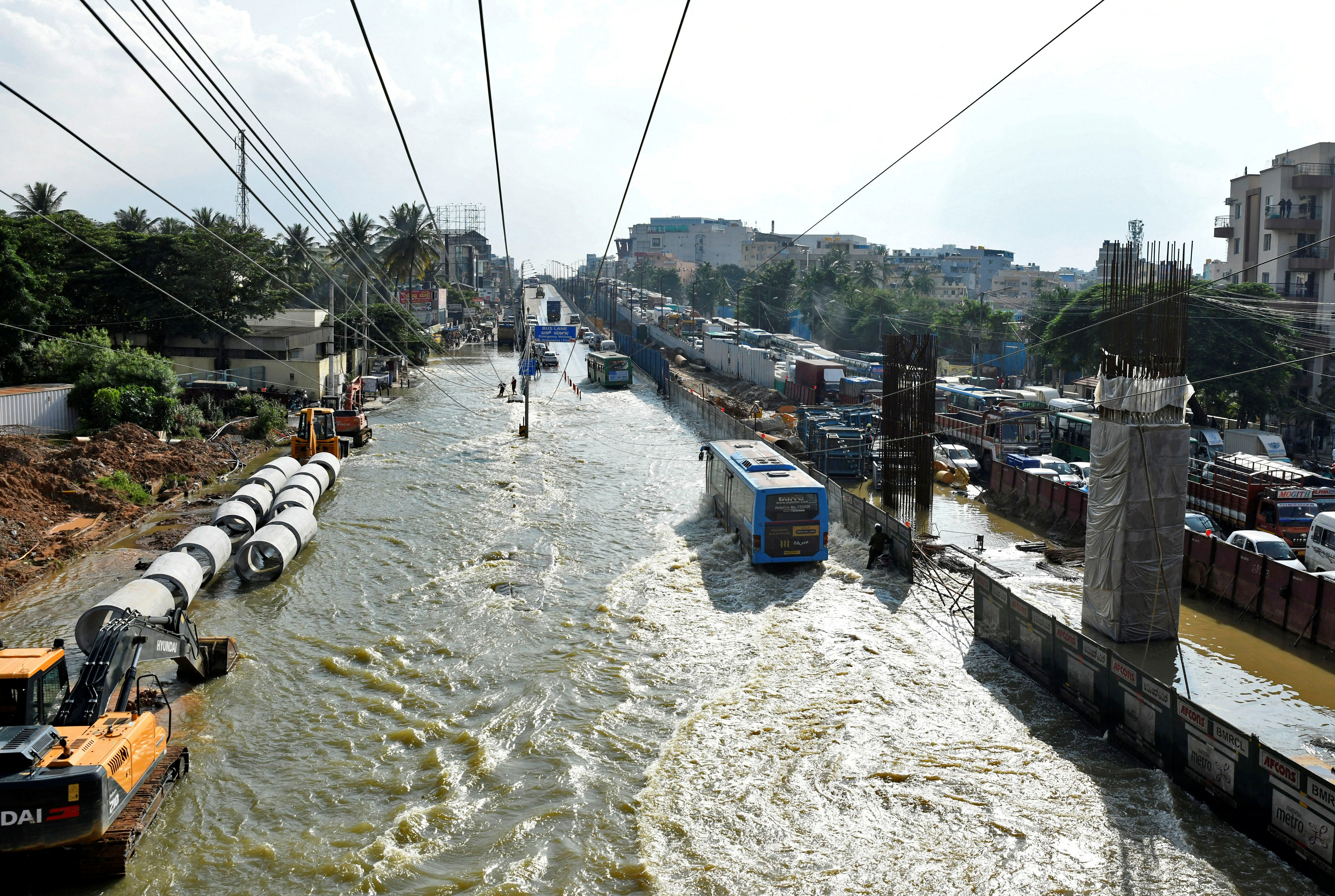 Traffic moves through waterlogged roads following torrential rains in Bengaluru