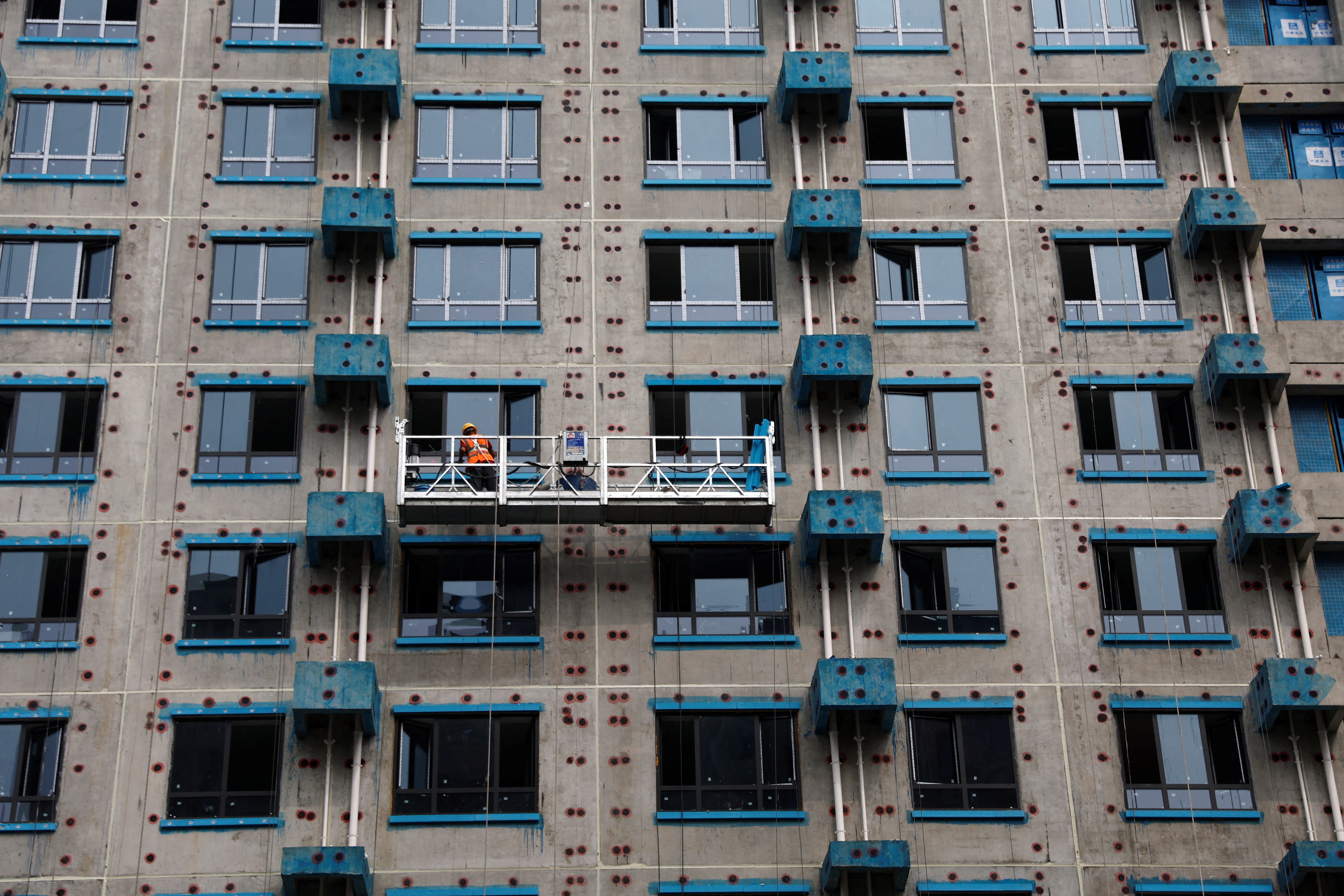 A person works on the construction site of an apartment building in Beijing