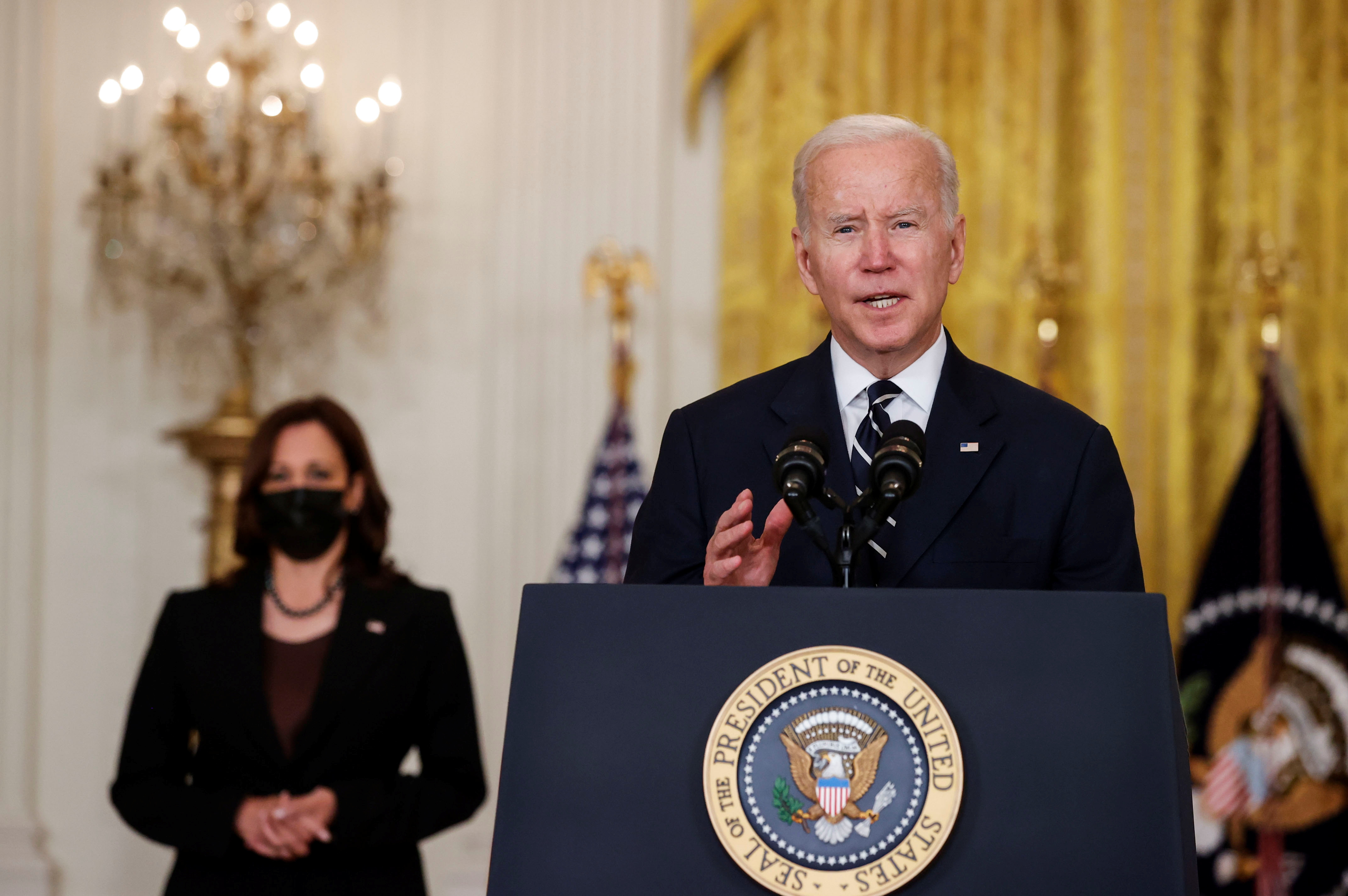 U.S. President Joe Biden delivers remarks about his Build Back Better agenda and the bipartisan infrastructure deal as Vice President Kamala Harris stands by in the East Room of the White House in Washington, U.S., October 28, 2021. REUTERS/Jonathan Ernst