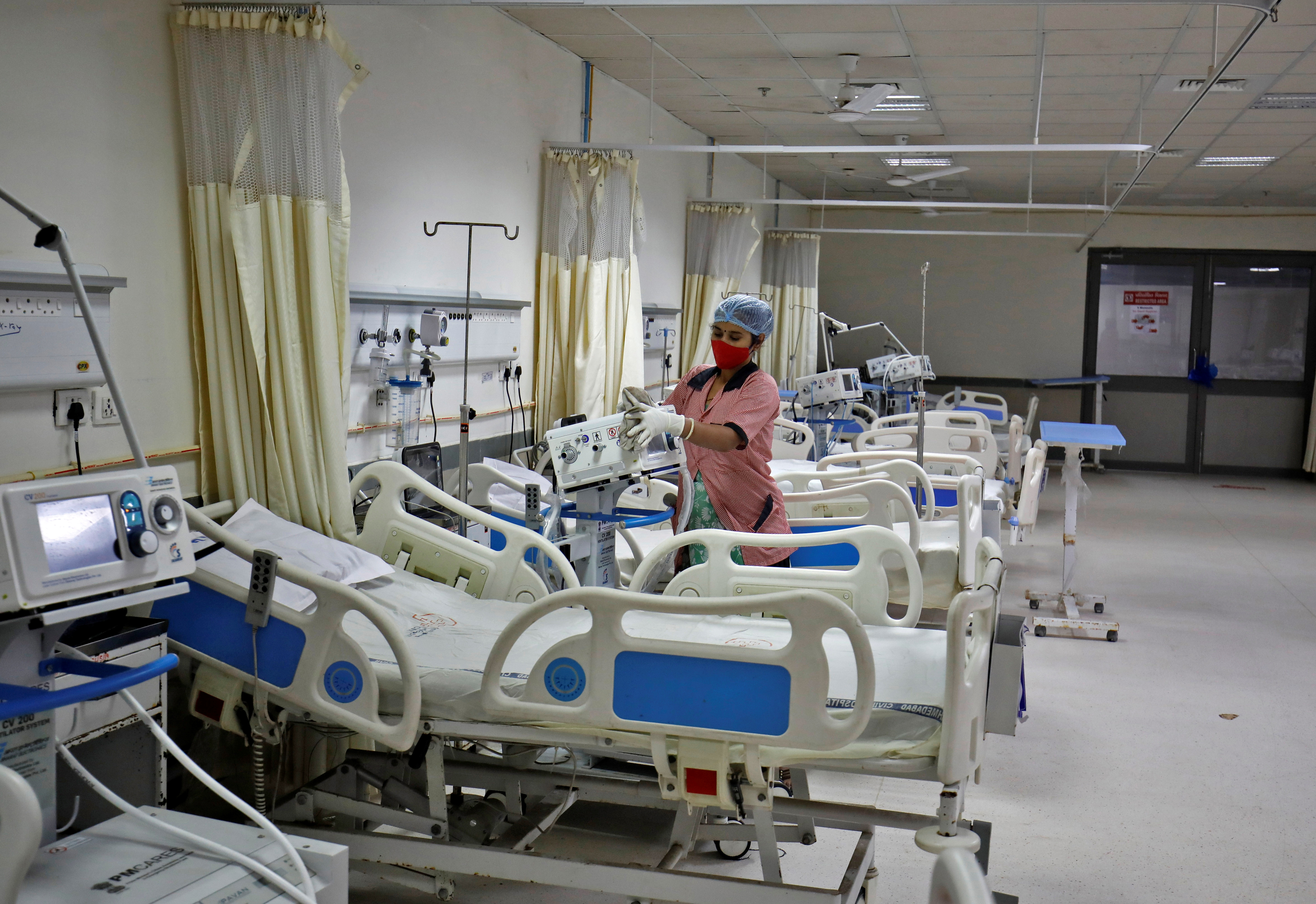 Staff member cleans medical equipment inside ward set up for Omicron coronavirus variant infected people at the Civil Hospital in Ahmedabad
