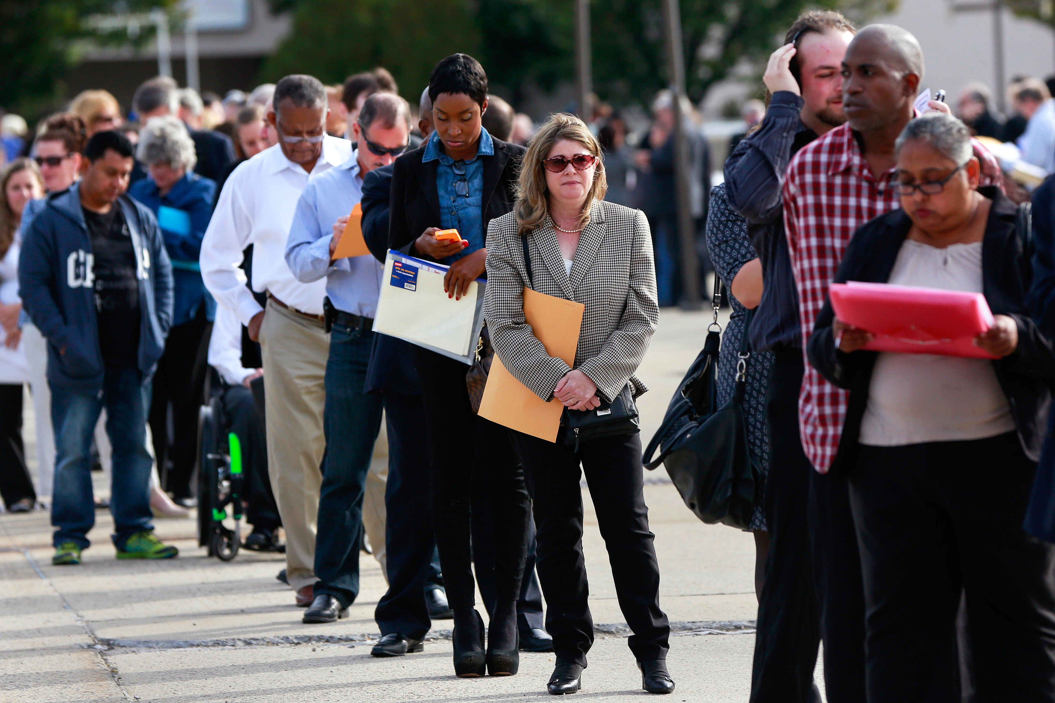 People wait in line to enter the Nassau County Mega Job Fair at Nassau Veterans Memorial Coliseum in Uniondale, New York October 7, 2014. U.S. job openings rose to their highest level in more than 13 years in August even as hiring fell, the U.S. Department of Labor said. REUTERS/Shannon Stapleton/File Photo