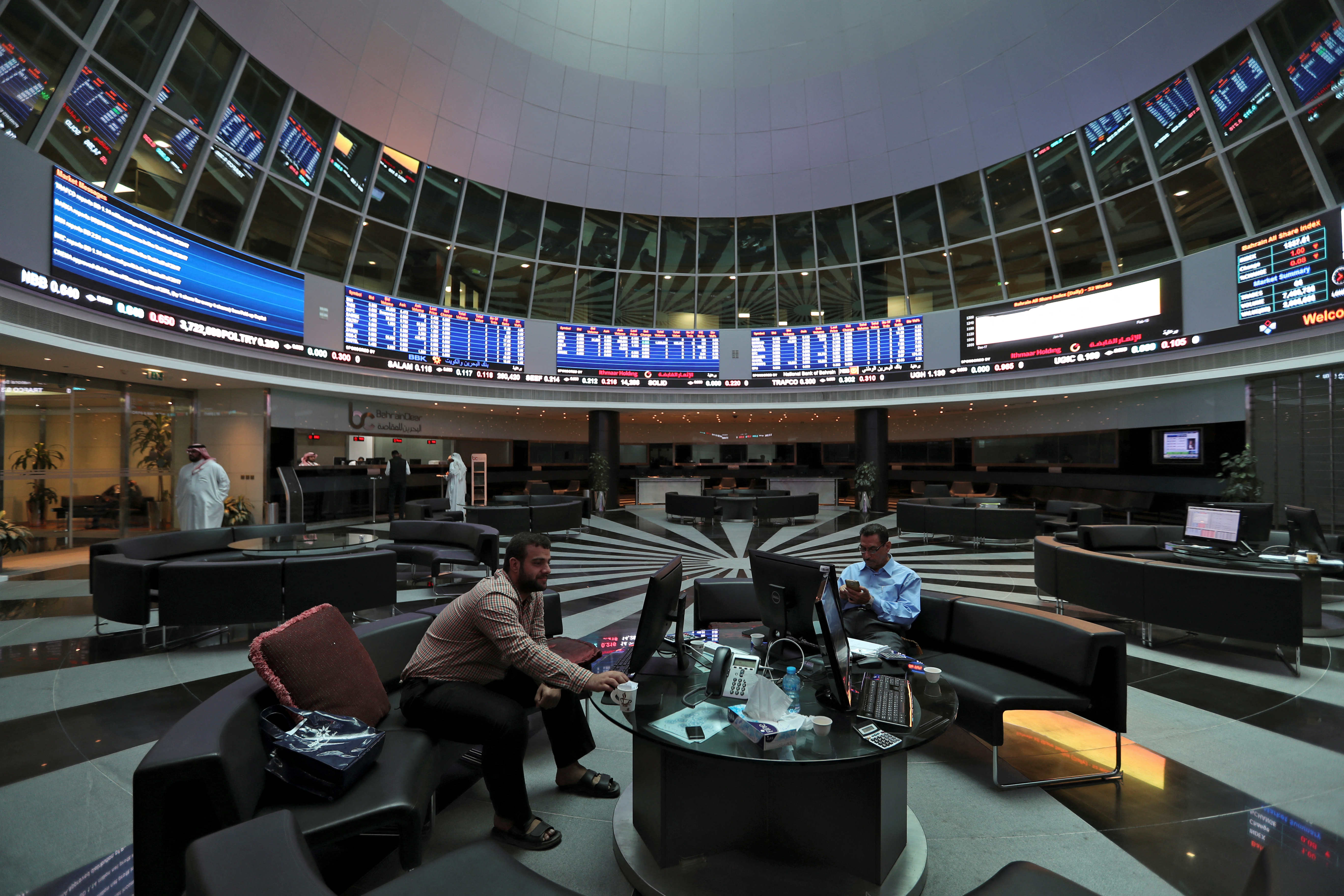 Traders look at the screens at Bahrain Bourse in Manama
