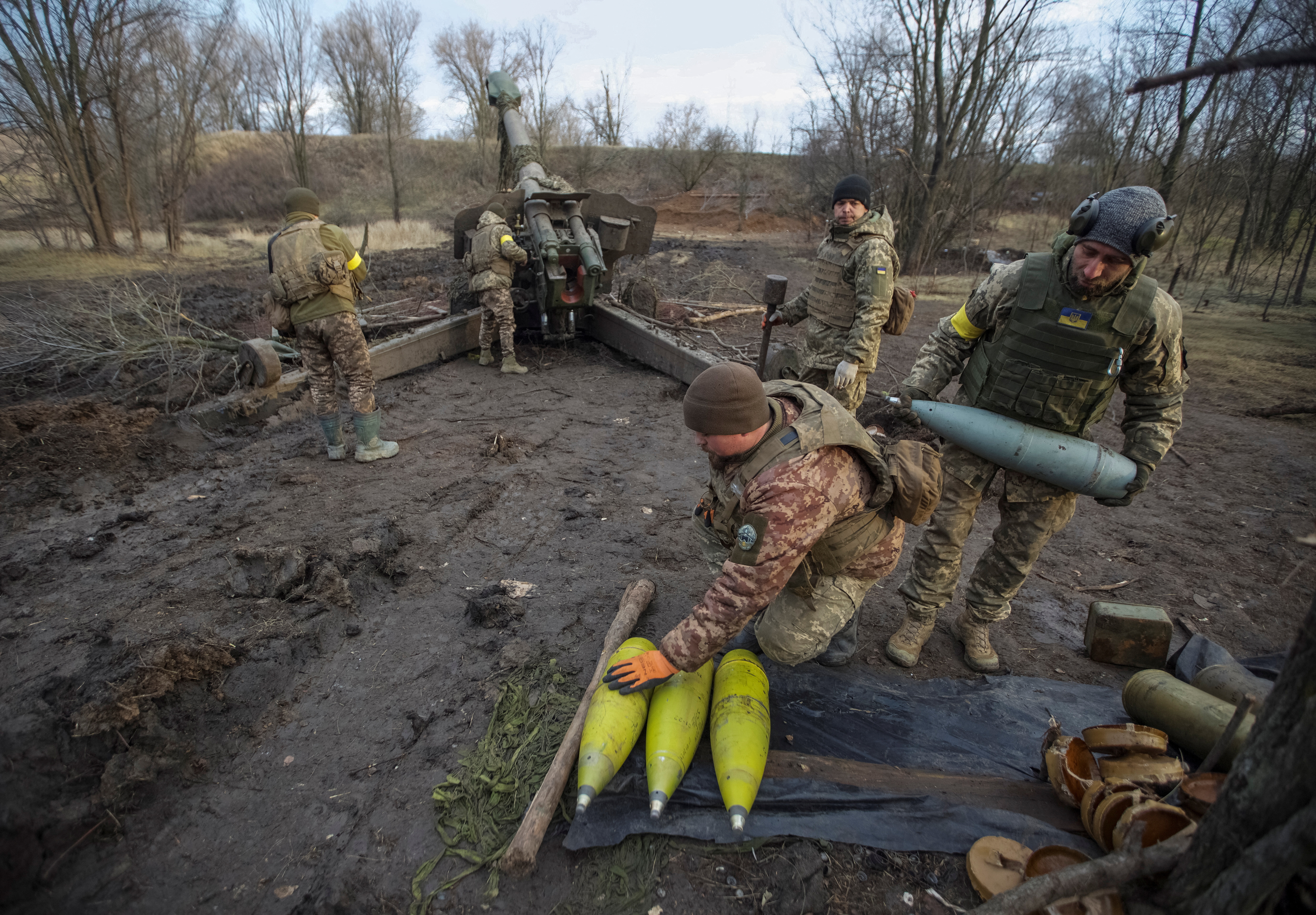 Ukrainian servicemen prepare cannon shells before firing them towards positions of Russian troops in Donetsk region