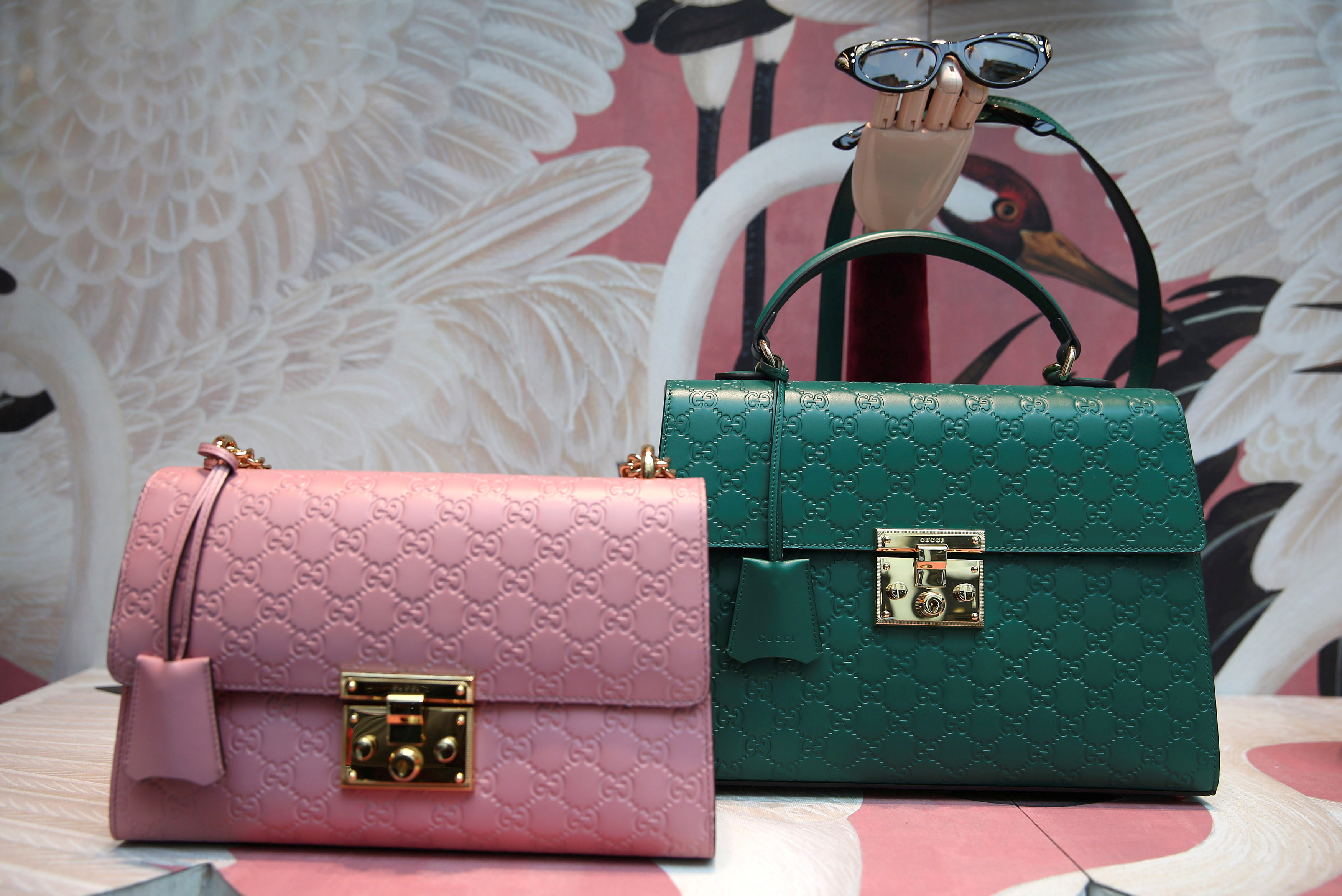 Gucci products are displayed in the window of a store on Old Bond Street in London