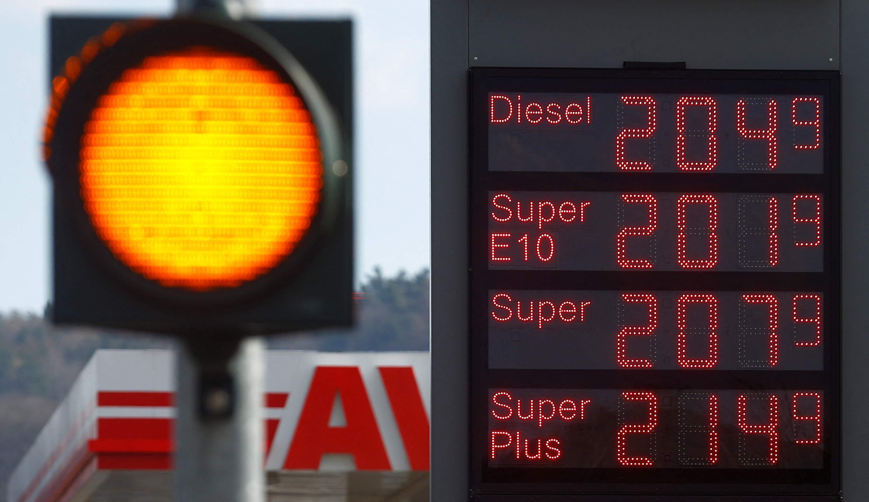 A display shows fuel prices per litre at a gas station in Ebersburg