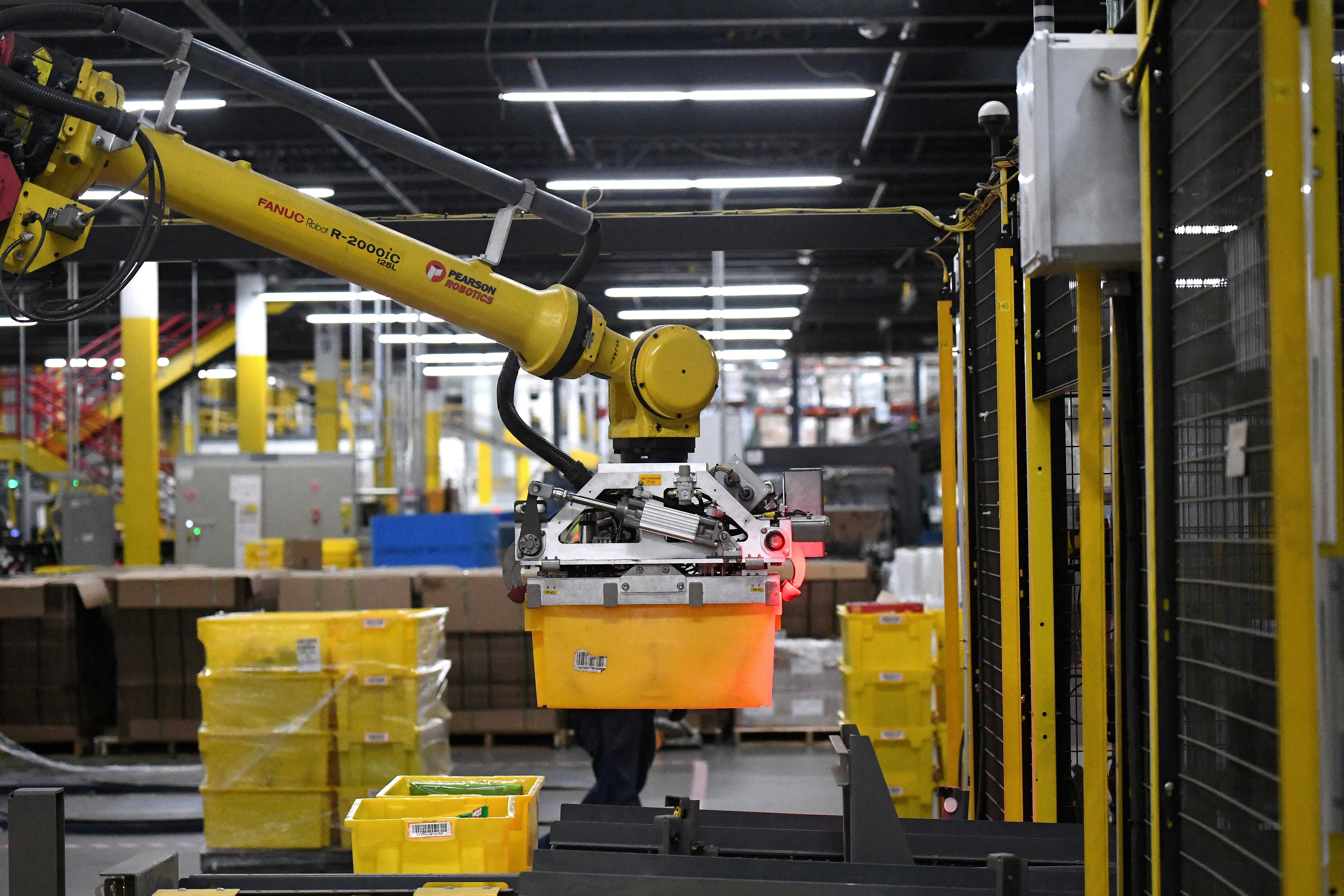 Six-axis robot arm picks up sorting containers at the Amazon fulfillment center in Baltimore
