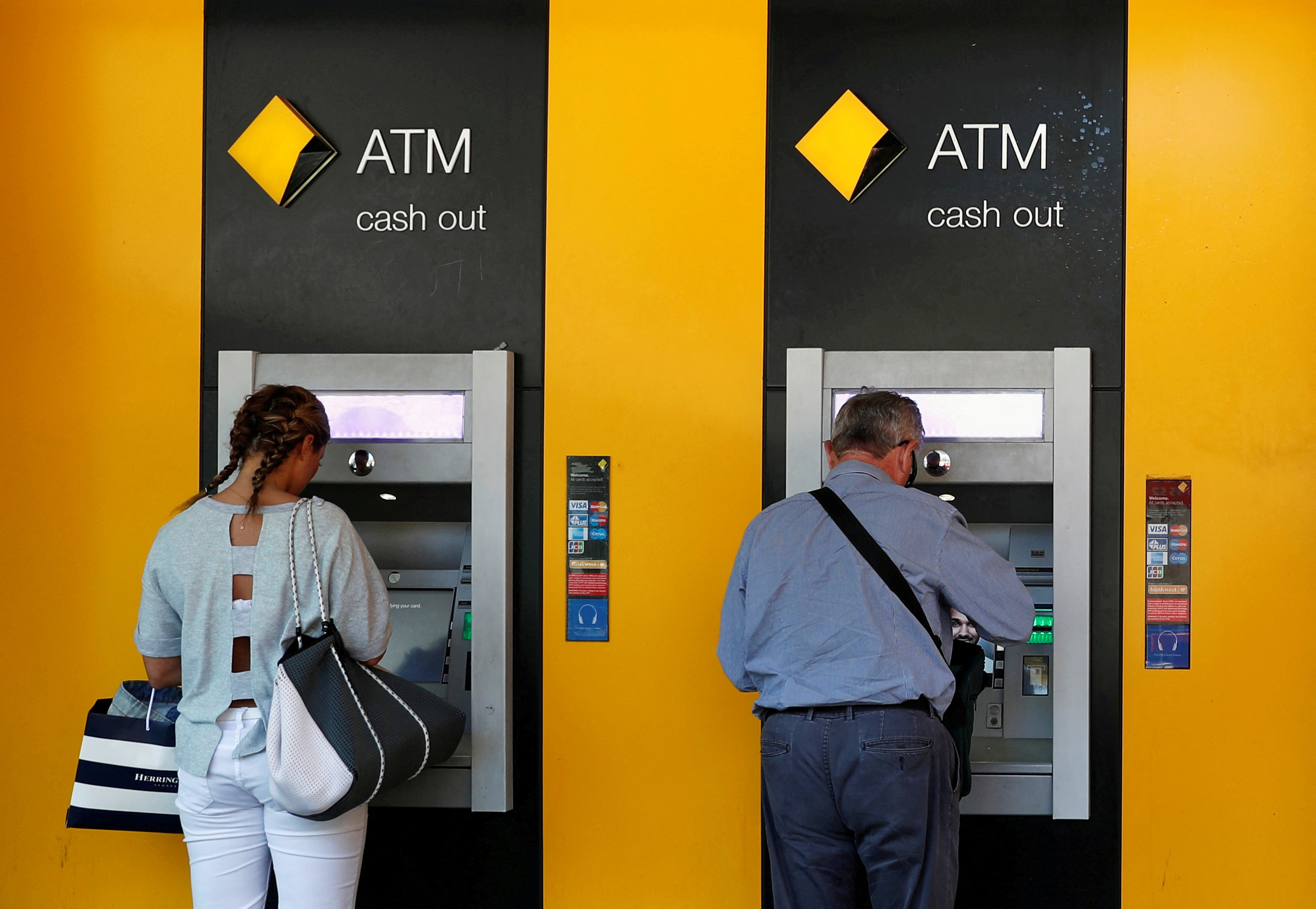 People use Commonwealth Bank of Australia (CBA) bank ATMs in Sydney