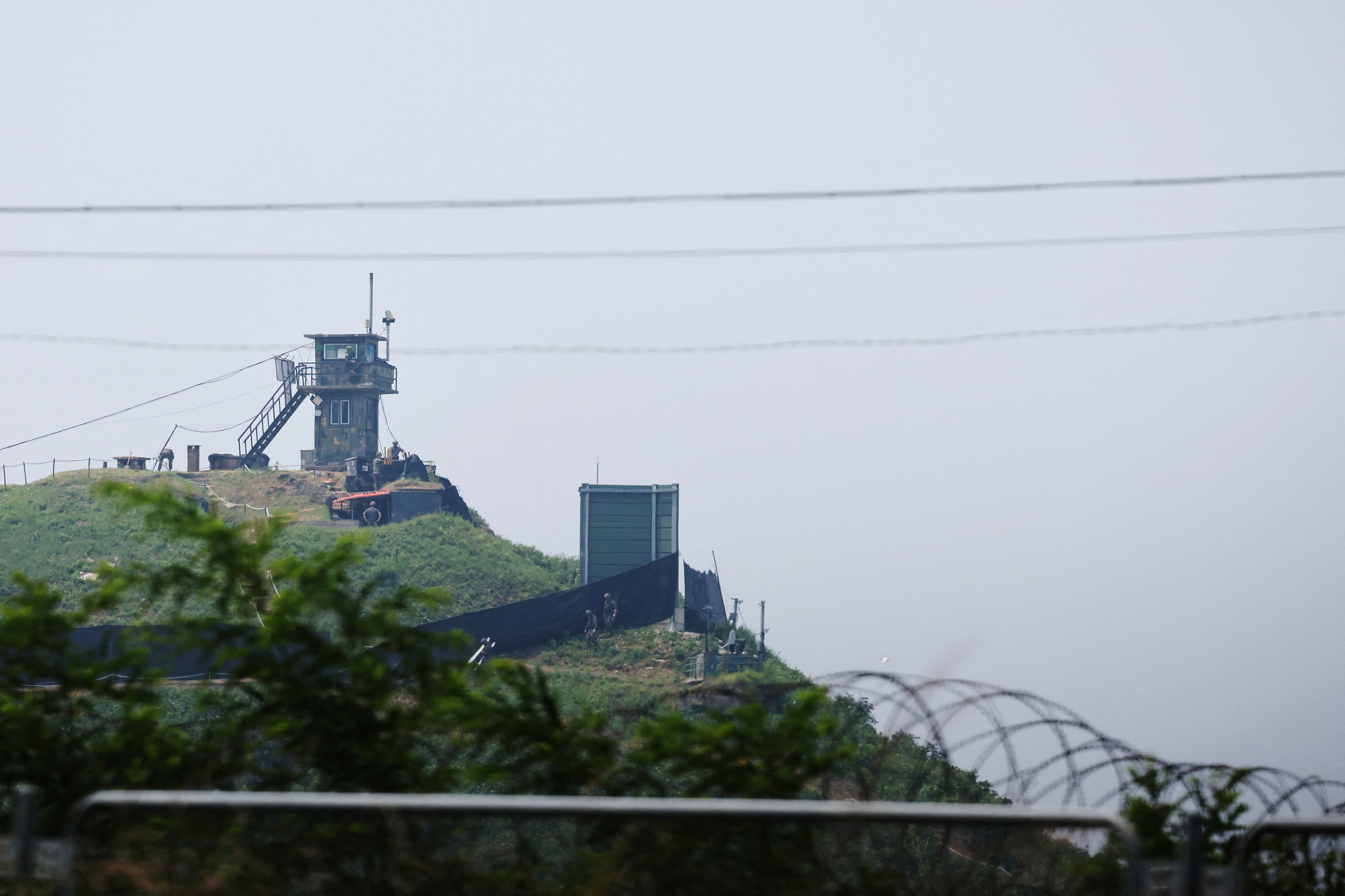 South Korean soldiers walk past a military facility where loudspeakers dismantled in 2018 used to be, near the demilitarized zone separating the two Koreas in Paju