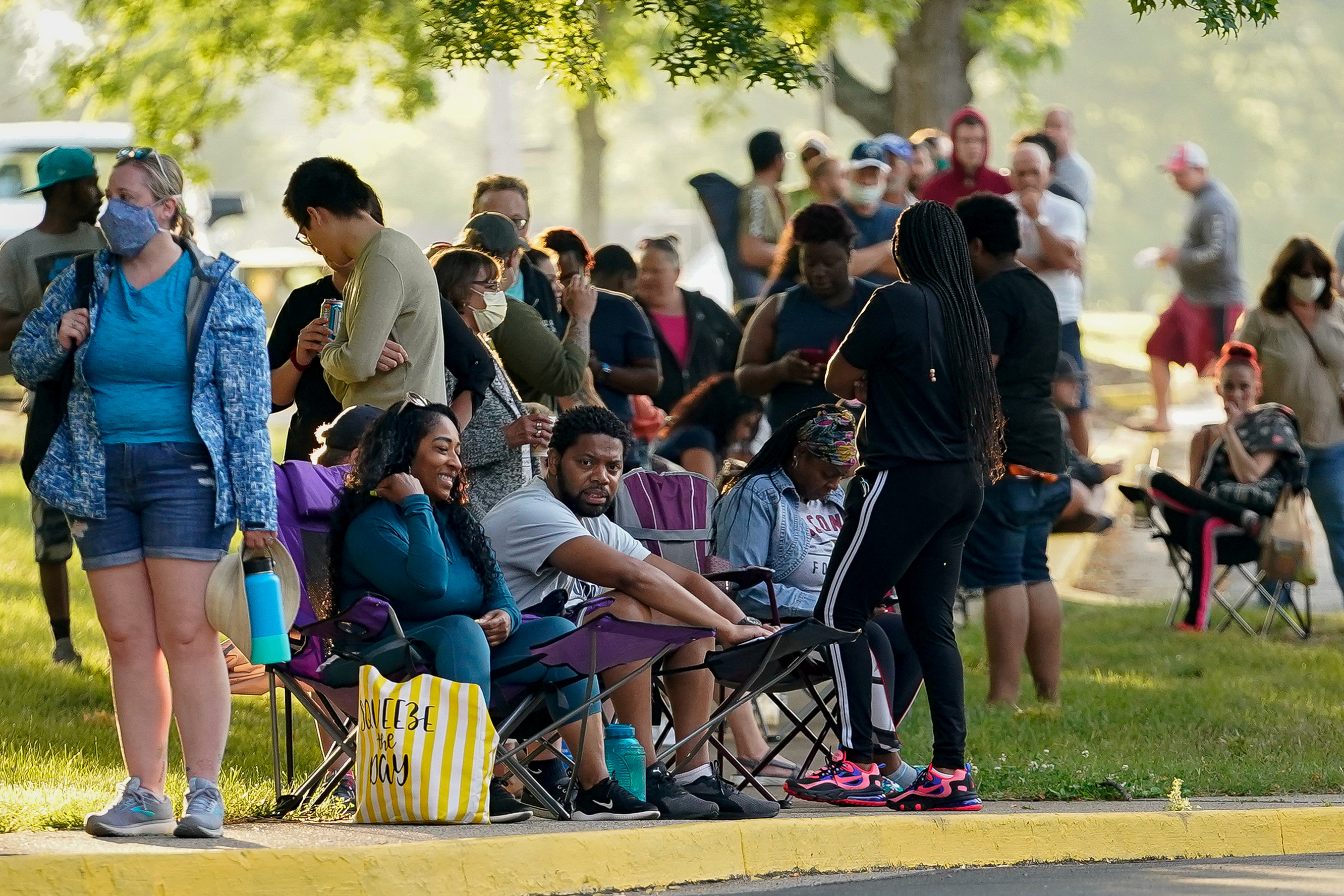 Hundreds of people line up outside the Kentucky Career Center, over two hours prior to its opening,  to find assistance with their unemployment claims, in Frankfort, Kentucky, U.S. June 18, 2020. REUTERS/Bryan Woolston