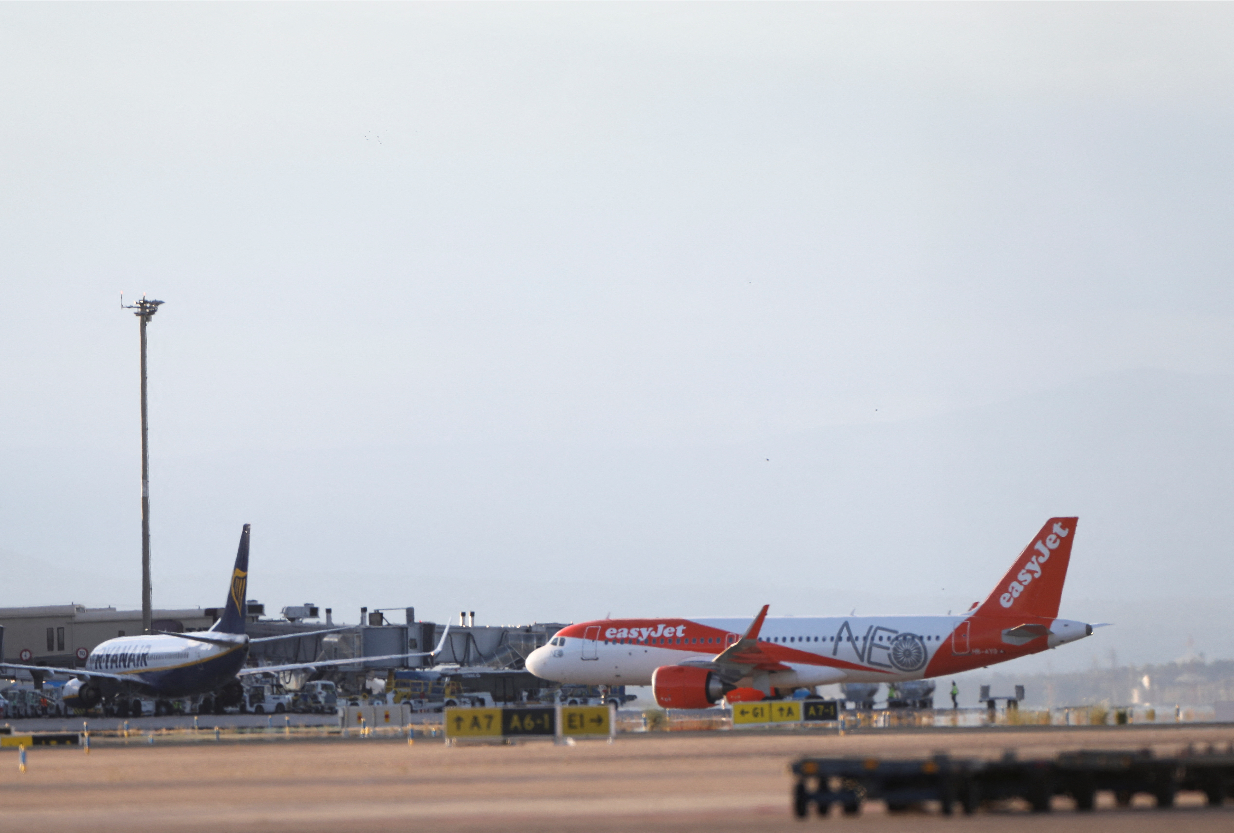 A Ryanair Boeing 737-8AS and an easyJet Airbus A320neo aircraft parked are seen on the tarmac of Adolfo Suarez Madrid-Barajas Airport, in Madrid