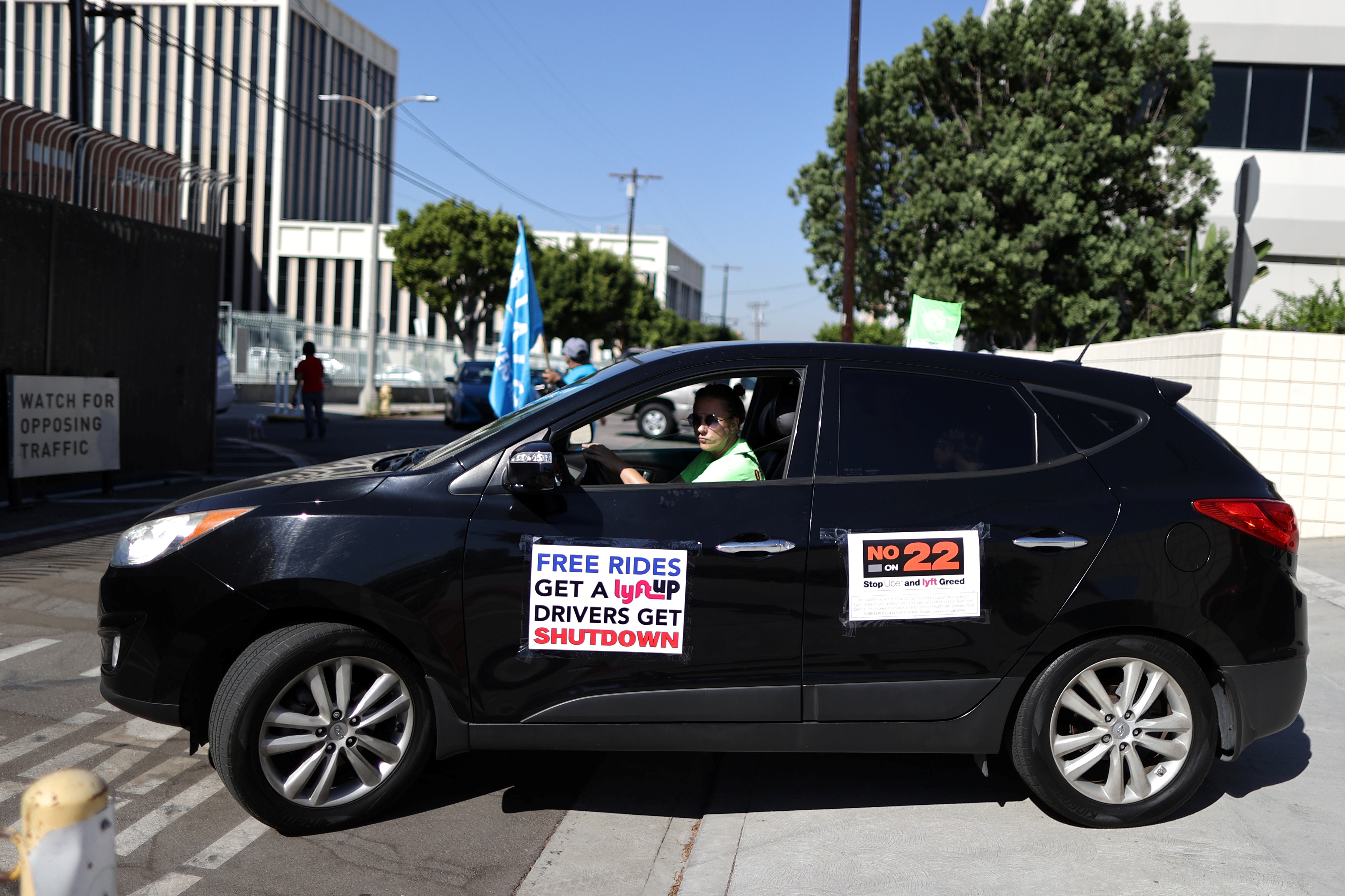 Uber and Lyft rideshare drivers participate in a protest against California Proposition 22 that would classify app-based drivers as independent contractors and not employees or agents, during the coronavirus disease (COVID-19) outbreak, in Los Angeles