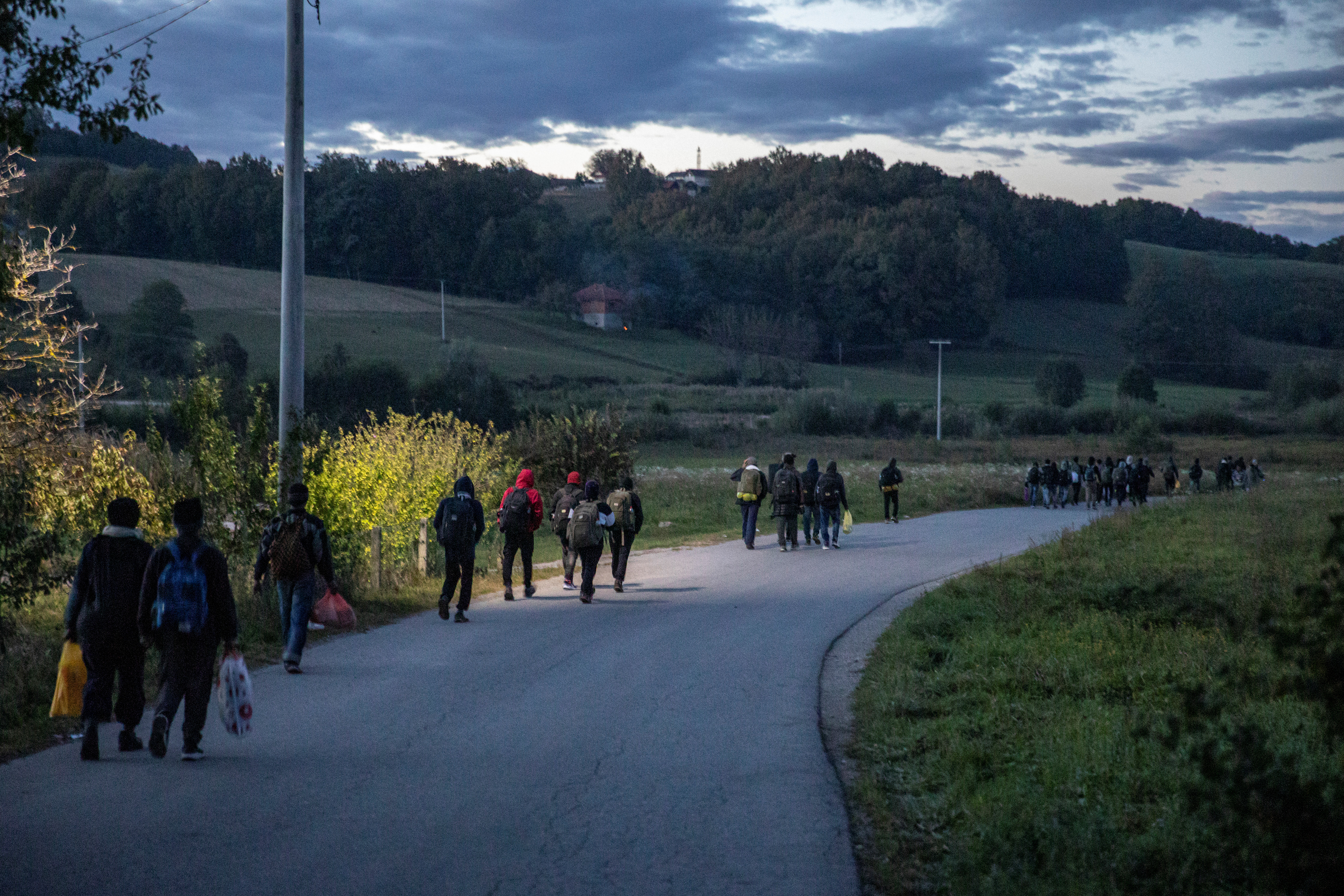 Migrants gather before trying to cross the Bosnia-Croatia border near Velika Kladusa