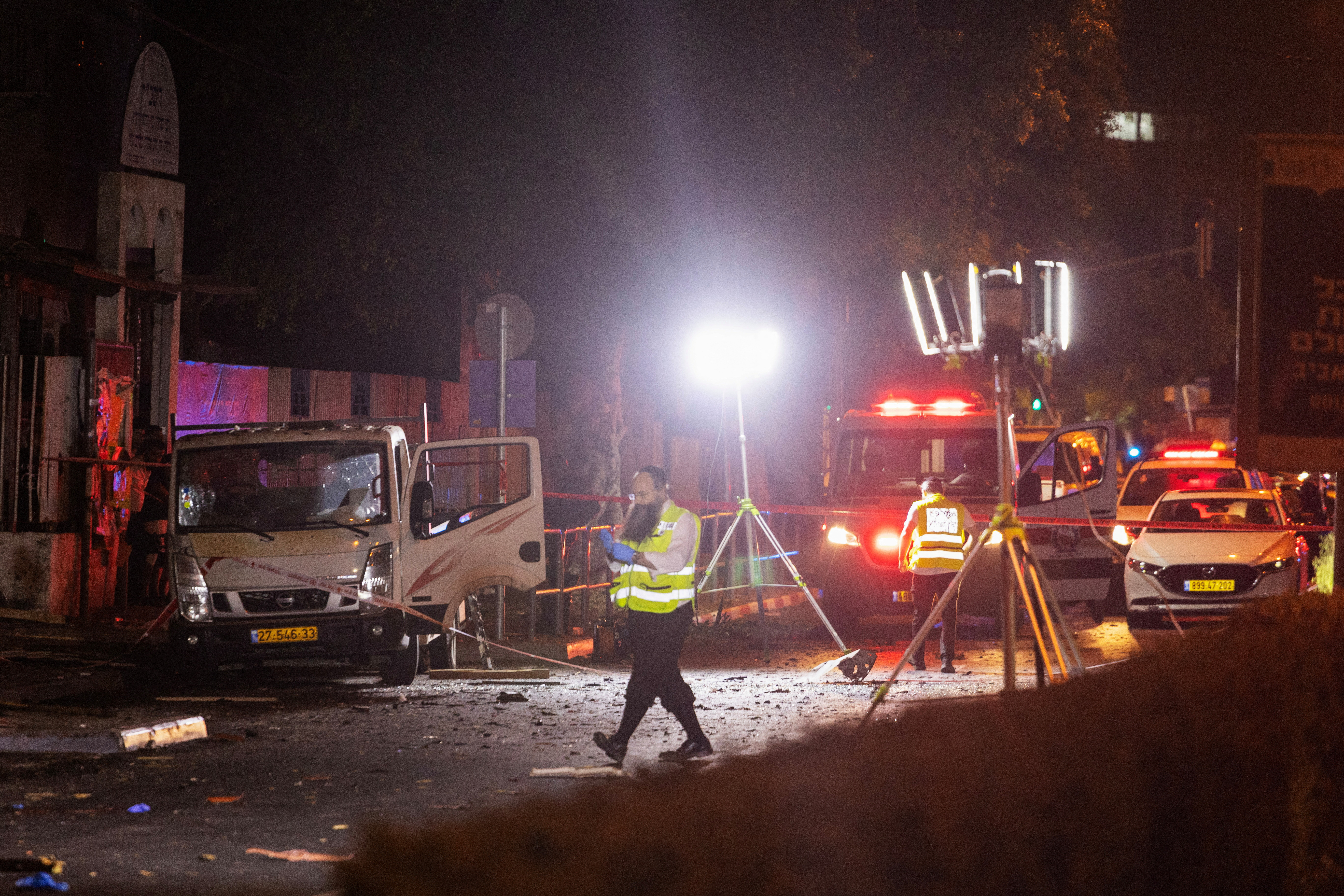 Emergency responders work at the site of a bomb blast in Tel Aviv