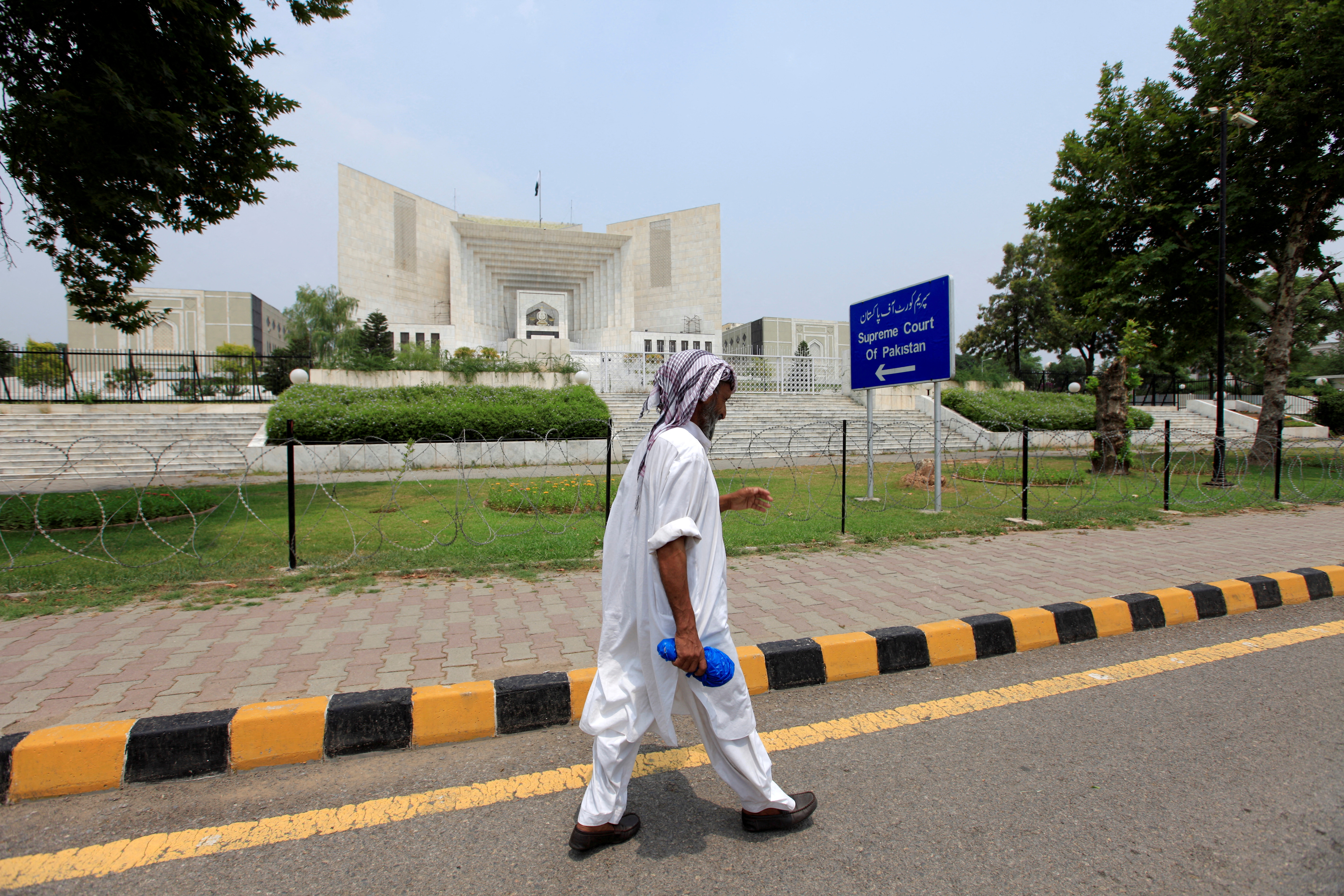 File photo of man walking past the Supreme Court building in Islamabad