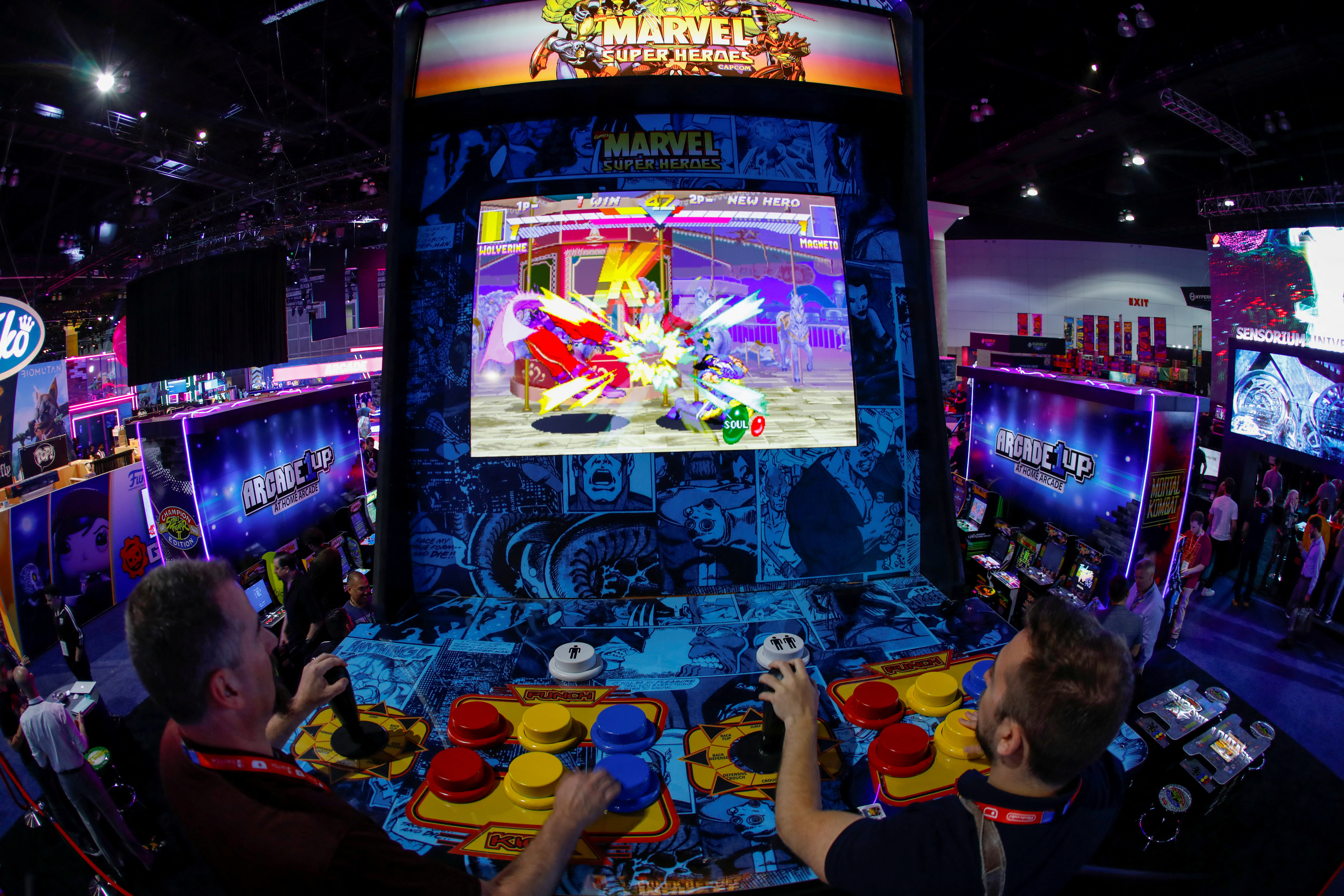 Attendees play a video game at E3, the annual video games expo experience the latest in gaming software and hardware in Los Angeles