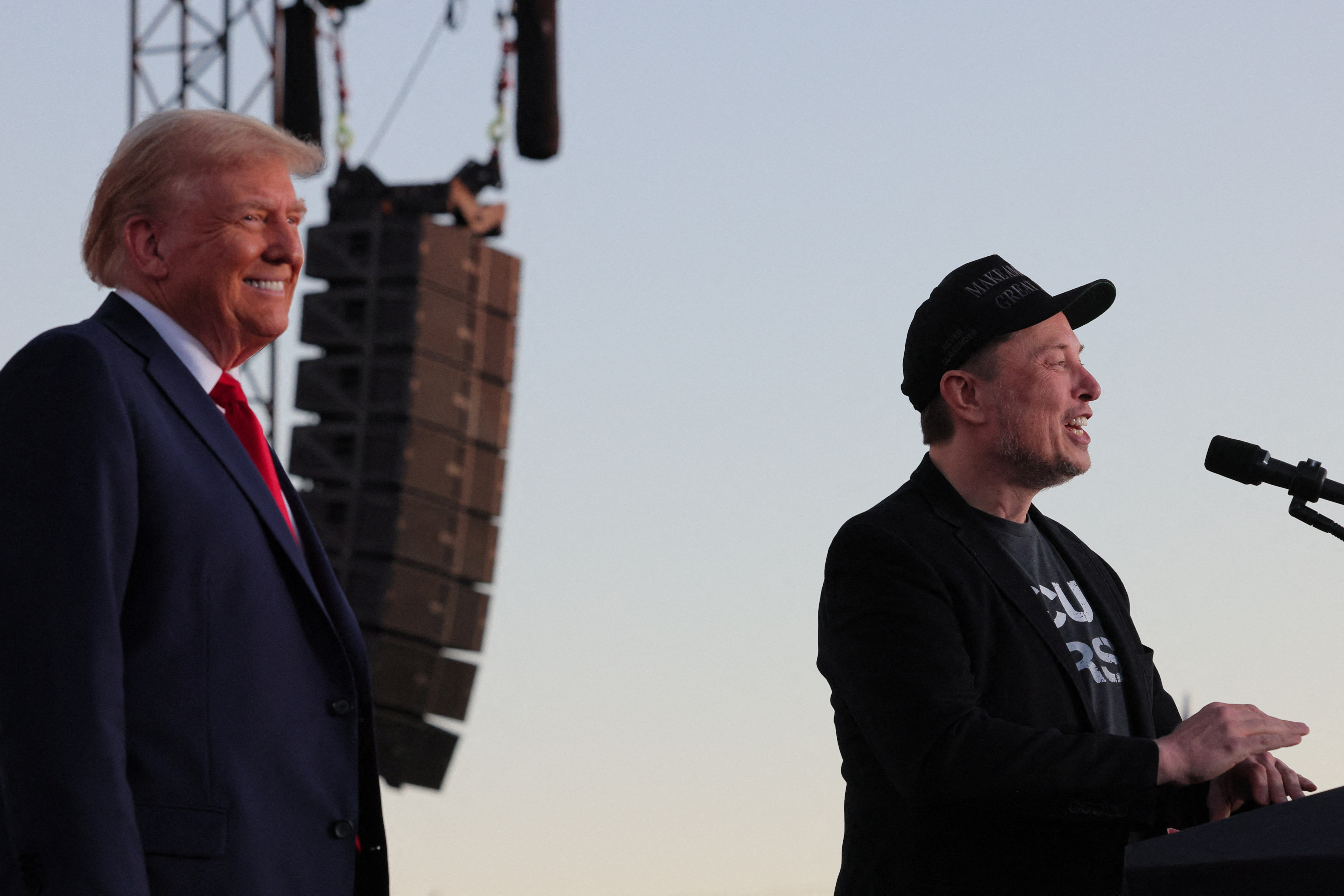 Tesla CEO and X owner Elon Musk speaks as Republican presidential nominee and former U.S. president Donald Trump looks on during a campaign rally, at the site of the July assassination attempt against Trump, in Butler, Pennsylvania, U.S., October 5, 2024. REUTERS/Brian Snyder