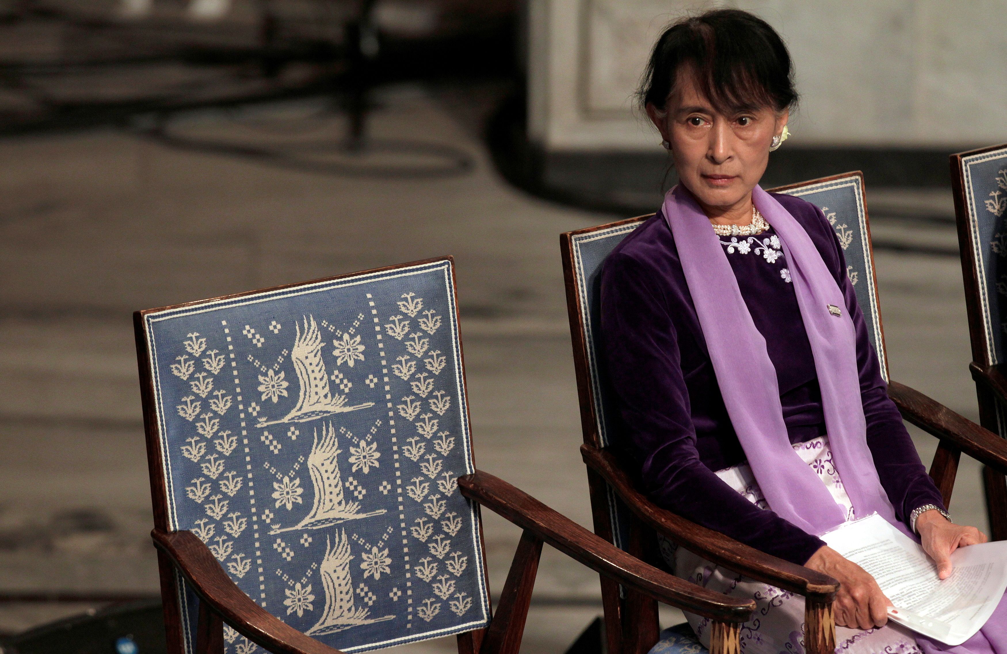 Myanmar opposition leader Aung San Suu Kyi sits before giving her Nobel Lecture at City Hall in Oslo