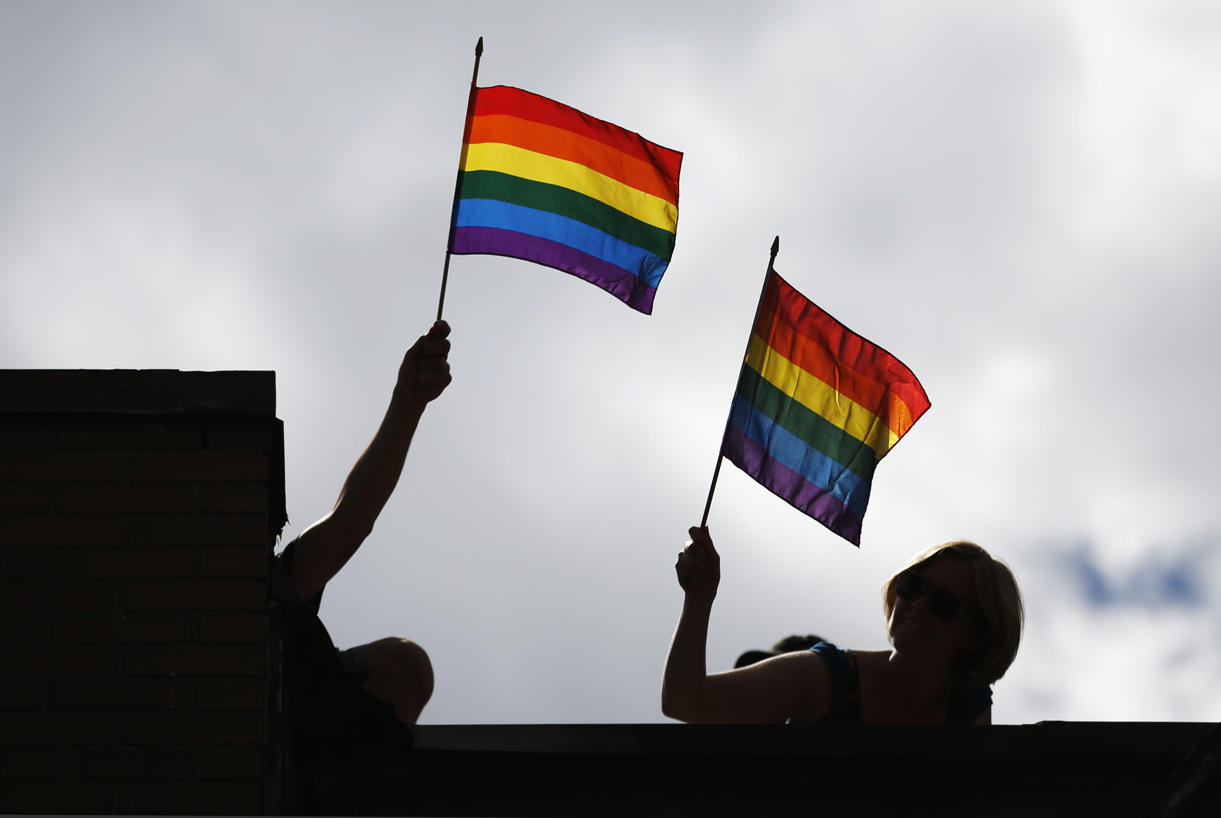 People hold pride flags during the Gay Pride parade in Toronto