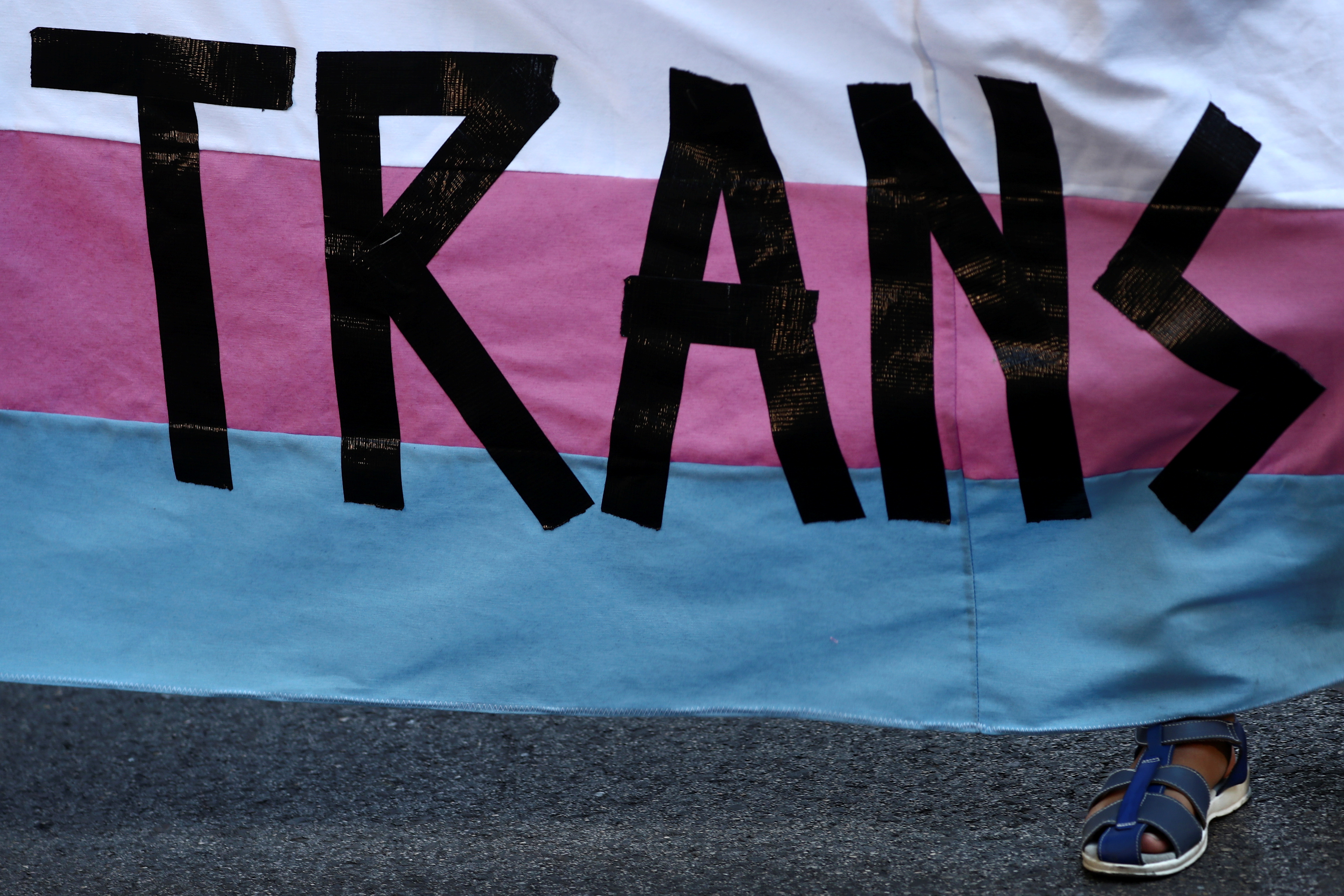 Pete, 9, a transgender minor, holds a banner as he takes part in a protest to mark LGBT Pride Day in Madrid, Spain, June 28, 2021. REUTERS/Sergio Perez