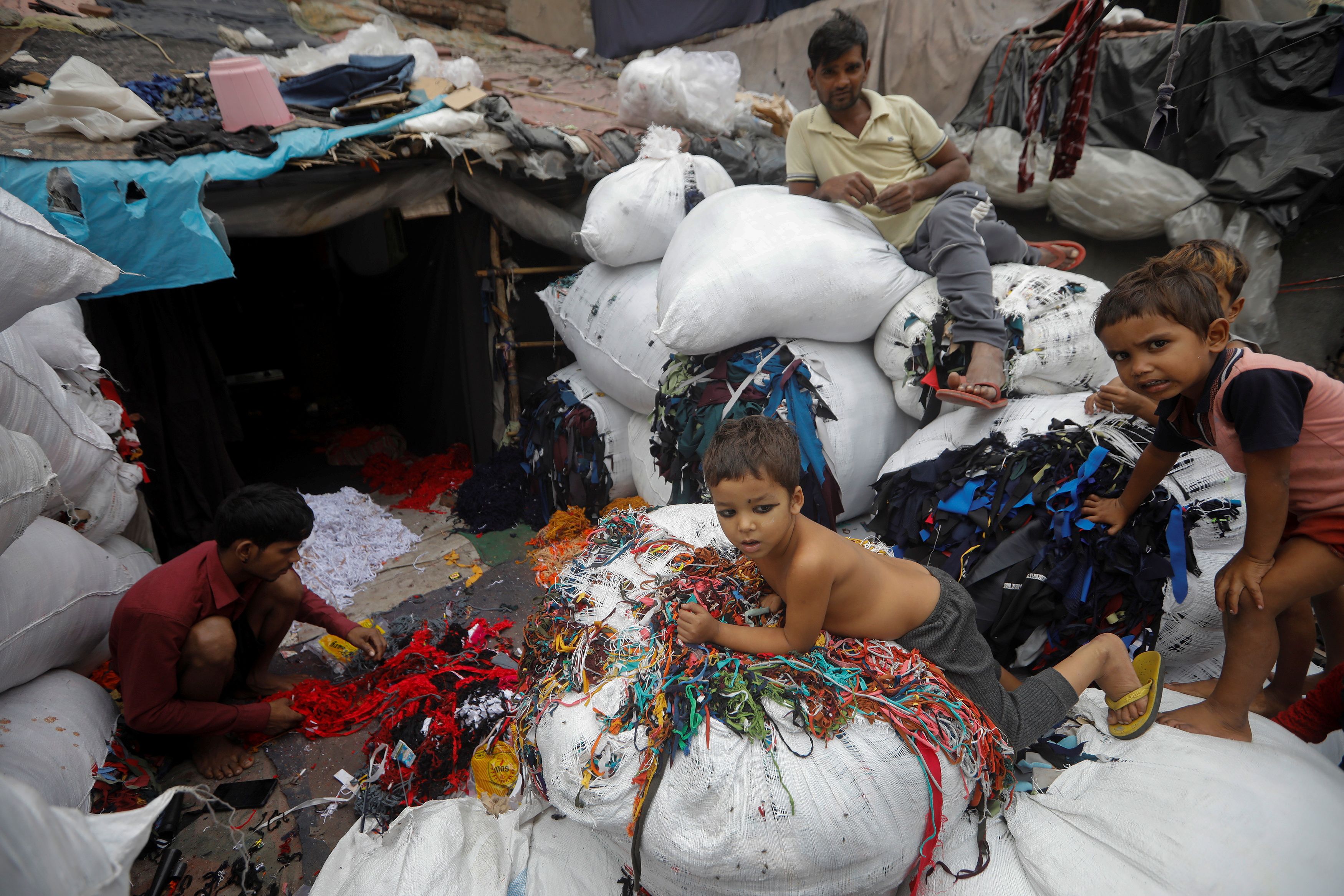 A man sorts discarded fabric waste at a market in New Delhi