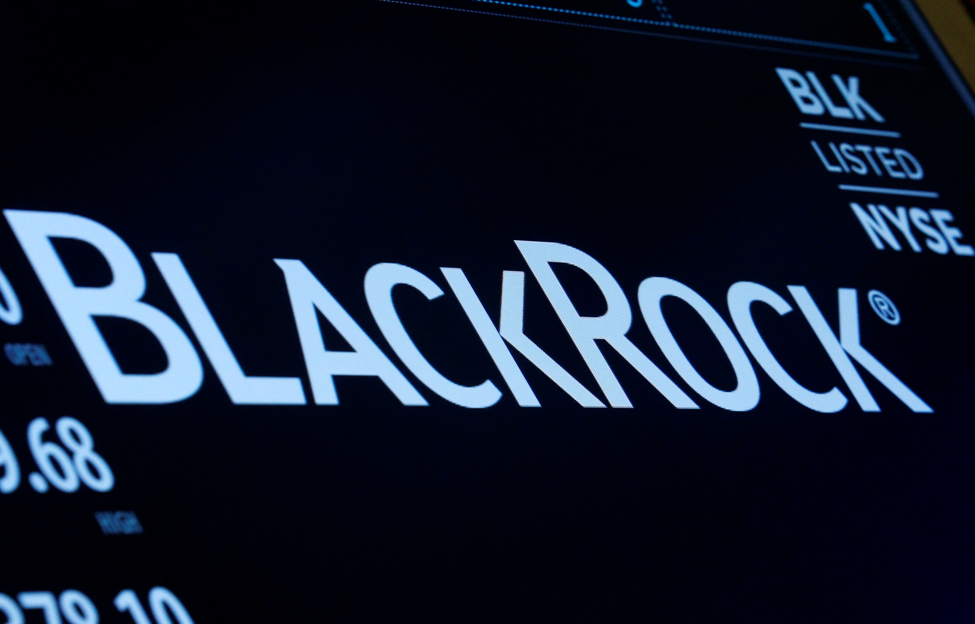 The company logo and trading information for BlackRock is displayed on a screen on the floor of the NYSE