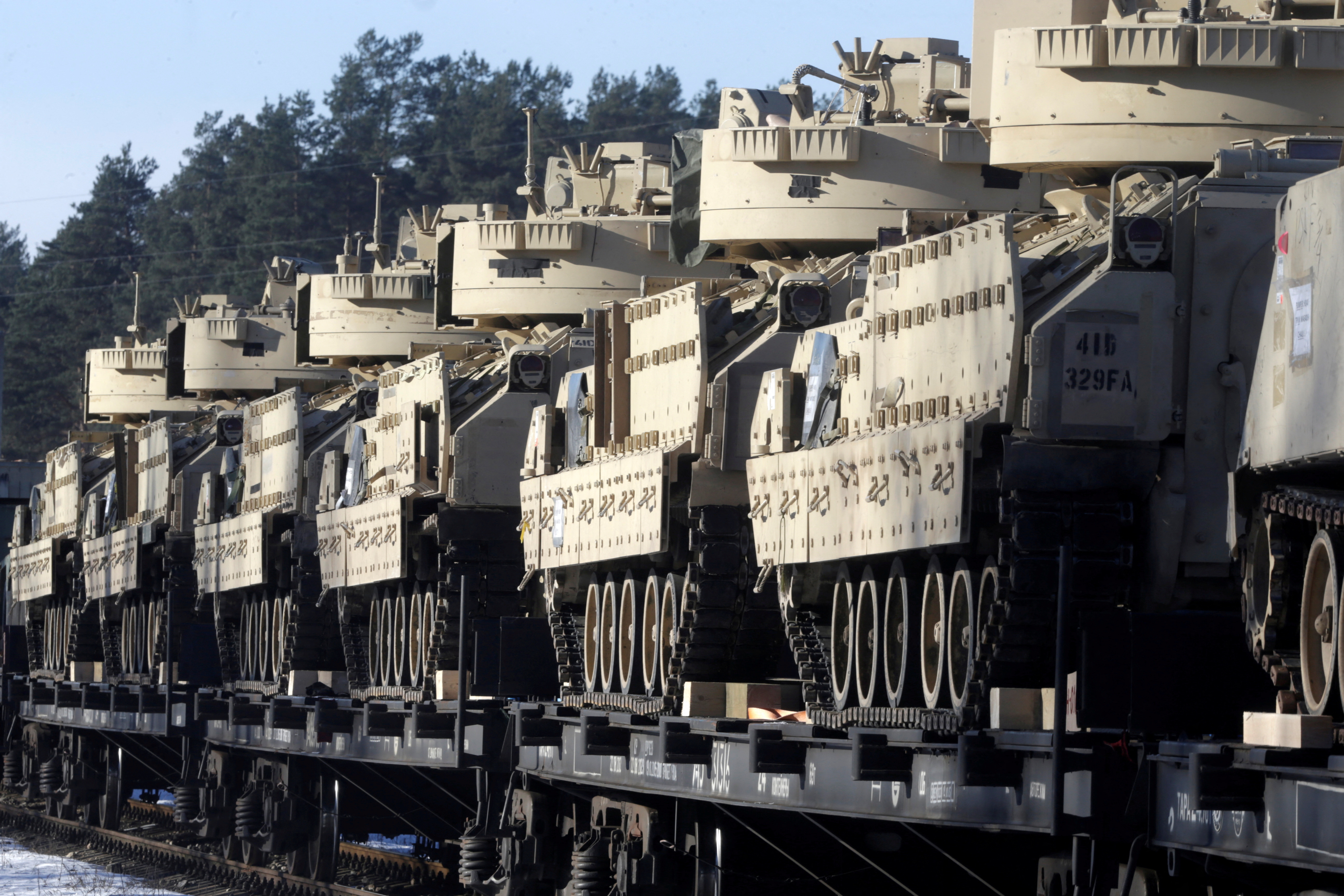 U.S. Bradley fighting vehicles that will be deployed in Latvia for NATO's Operation Atlantic Resolve wait for an unload in Garkalne