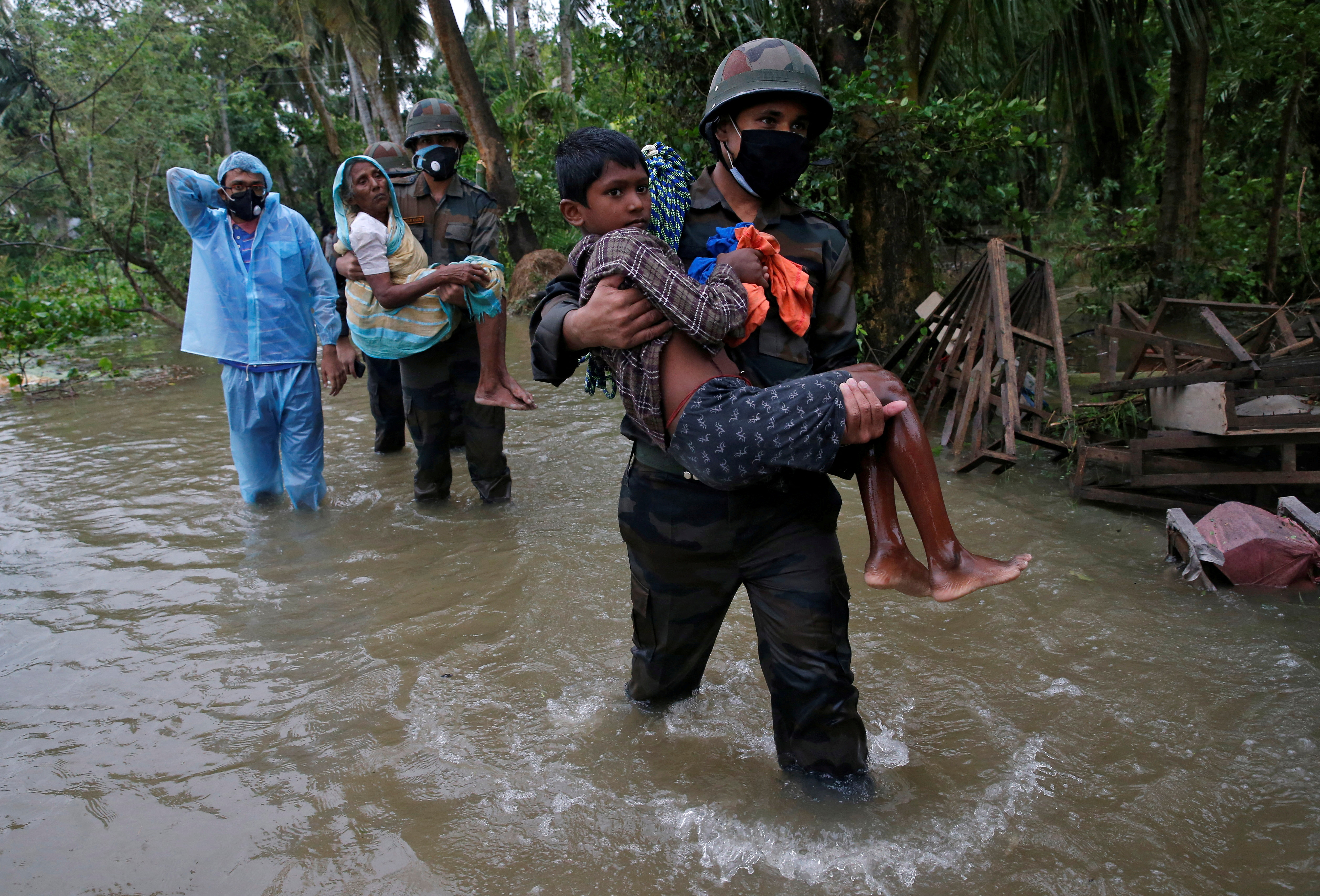 Army soldiers evacuate people from a flooded area to safer places as Cyclone Yaas makes landfall at Ramnagar