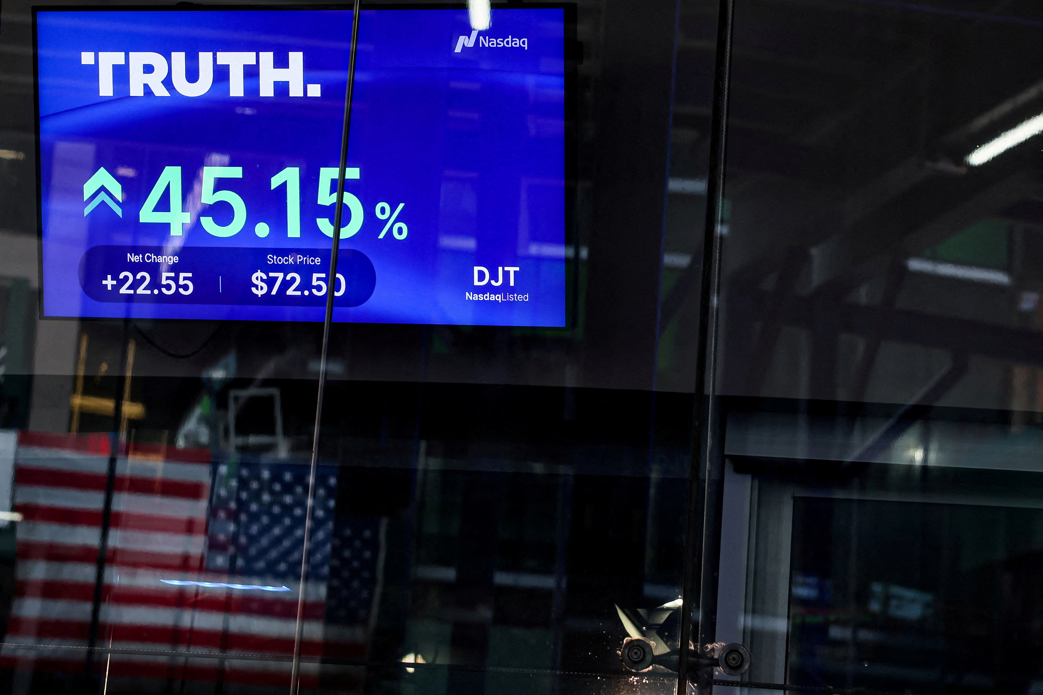 A screen displays trading information about shares of Truth Social and Trump Media & Technology Group, outside the Nasdaq Market site in New York City