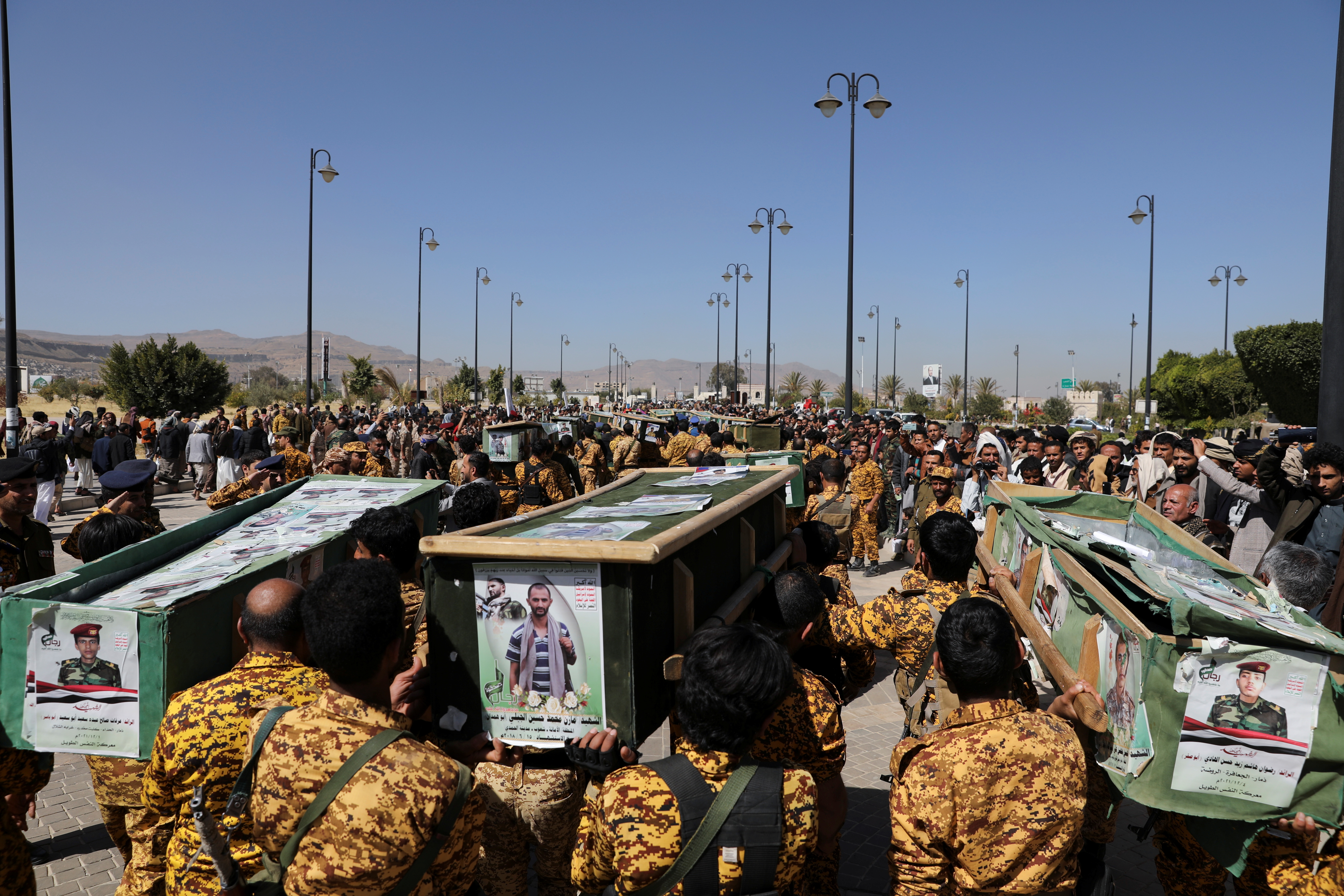 Police troopers carry the coffins of Houthi fighters killed in recent fighting against government forces, during their funeral in Sanaa, Yemen December 6, 2021. REUTERS/Khaled Abdullah
