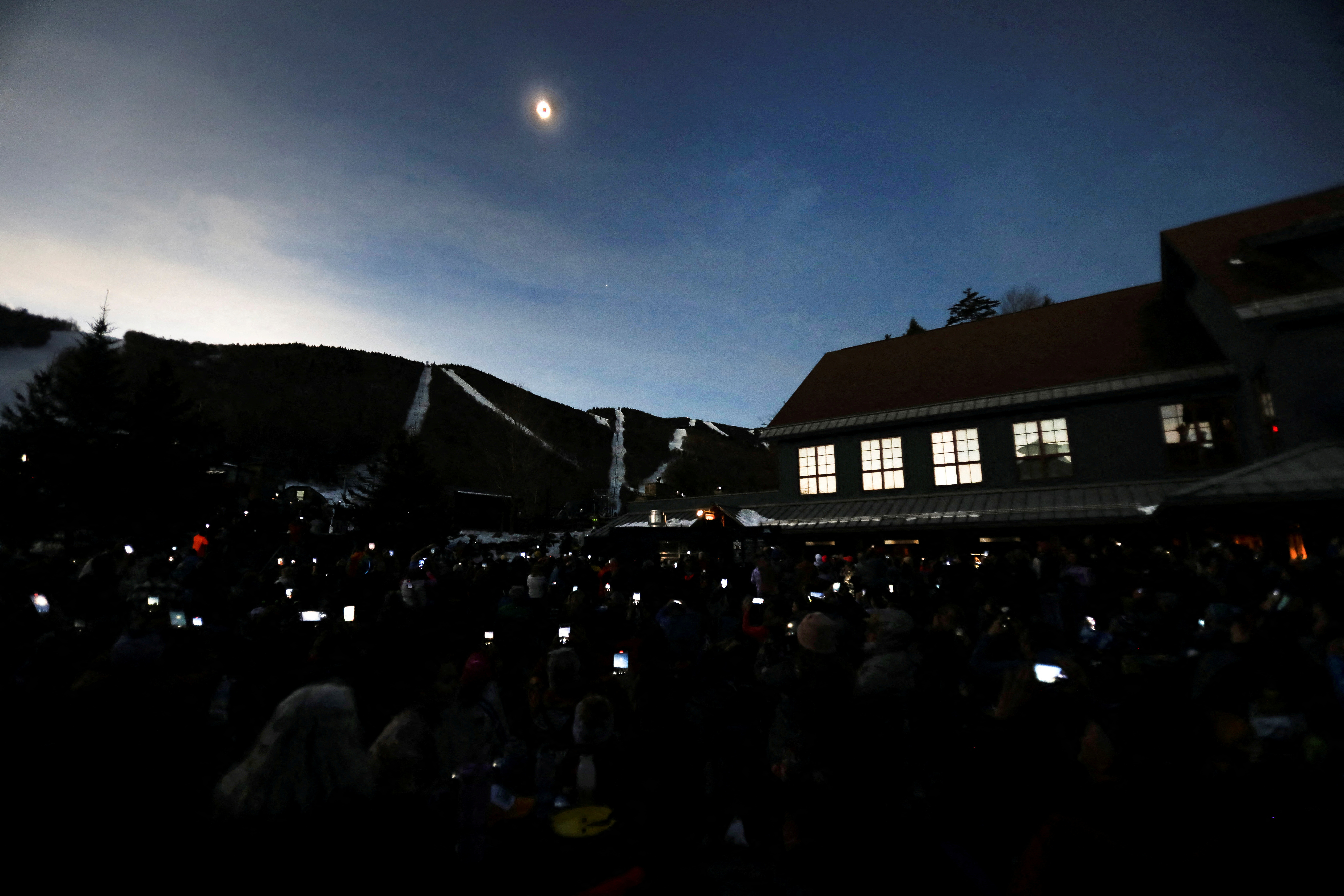 People assemble to view the total solar eclipse at Sugarbush ski resort