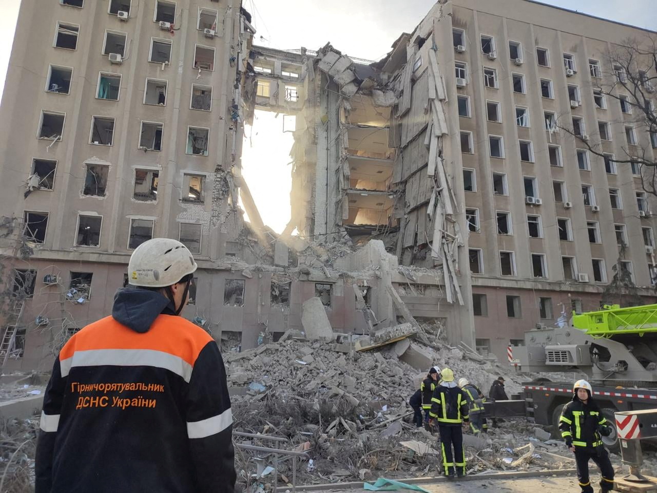 Rescuers work at a site of the regional administration building hit by cruise missiles in Mykolaiv