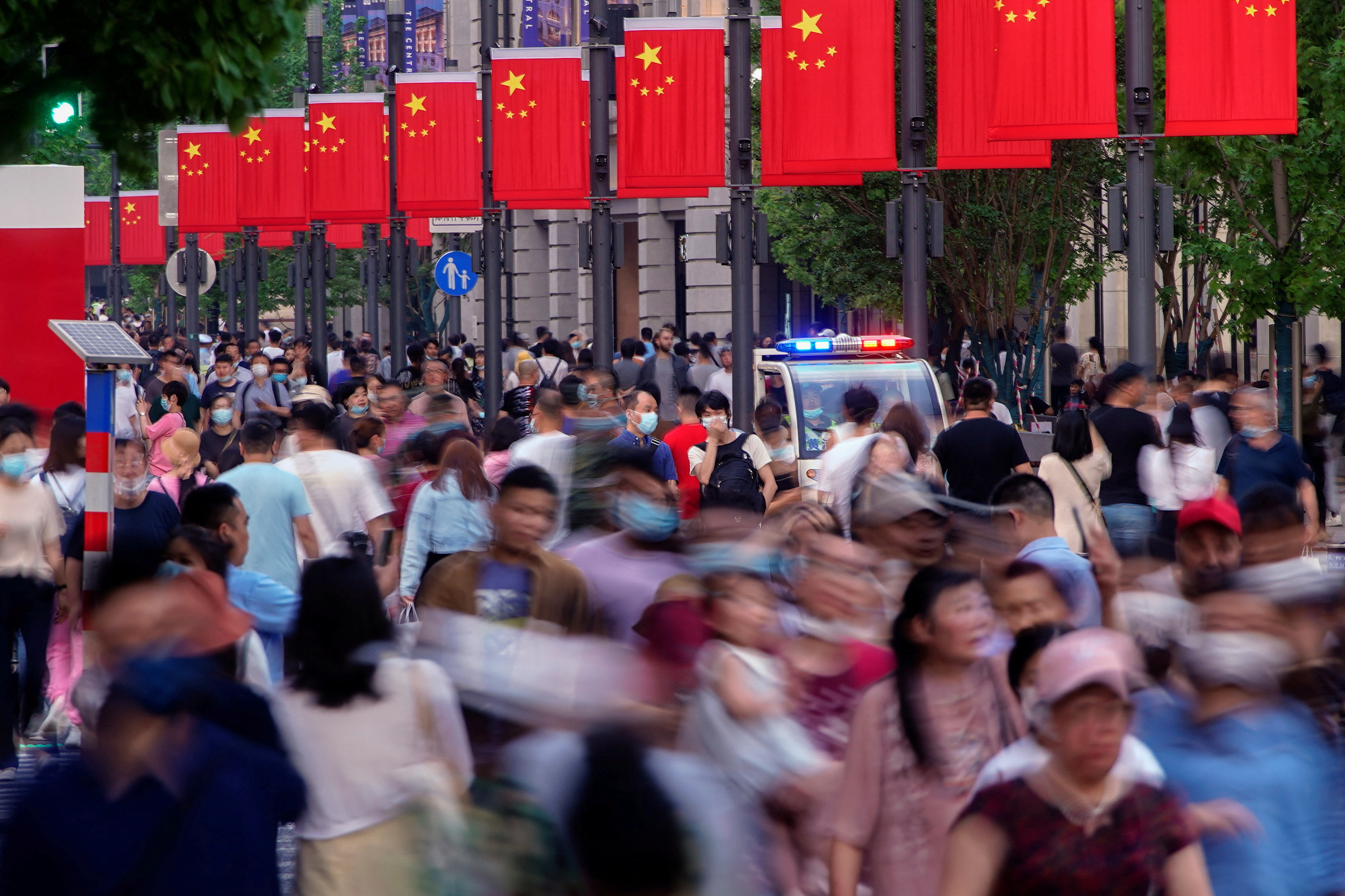 People walk along Nanjing Pedestrian Road, a major shopping district, after the outbreak of the coronavirus disease (COVID-19), in Shanghai