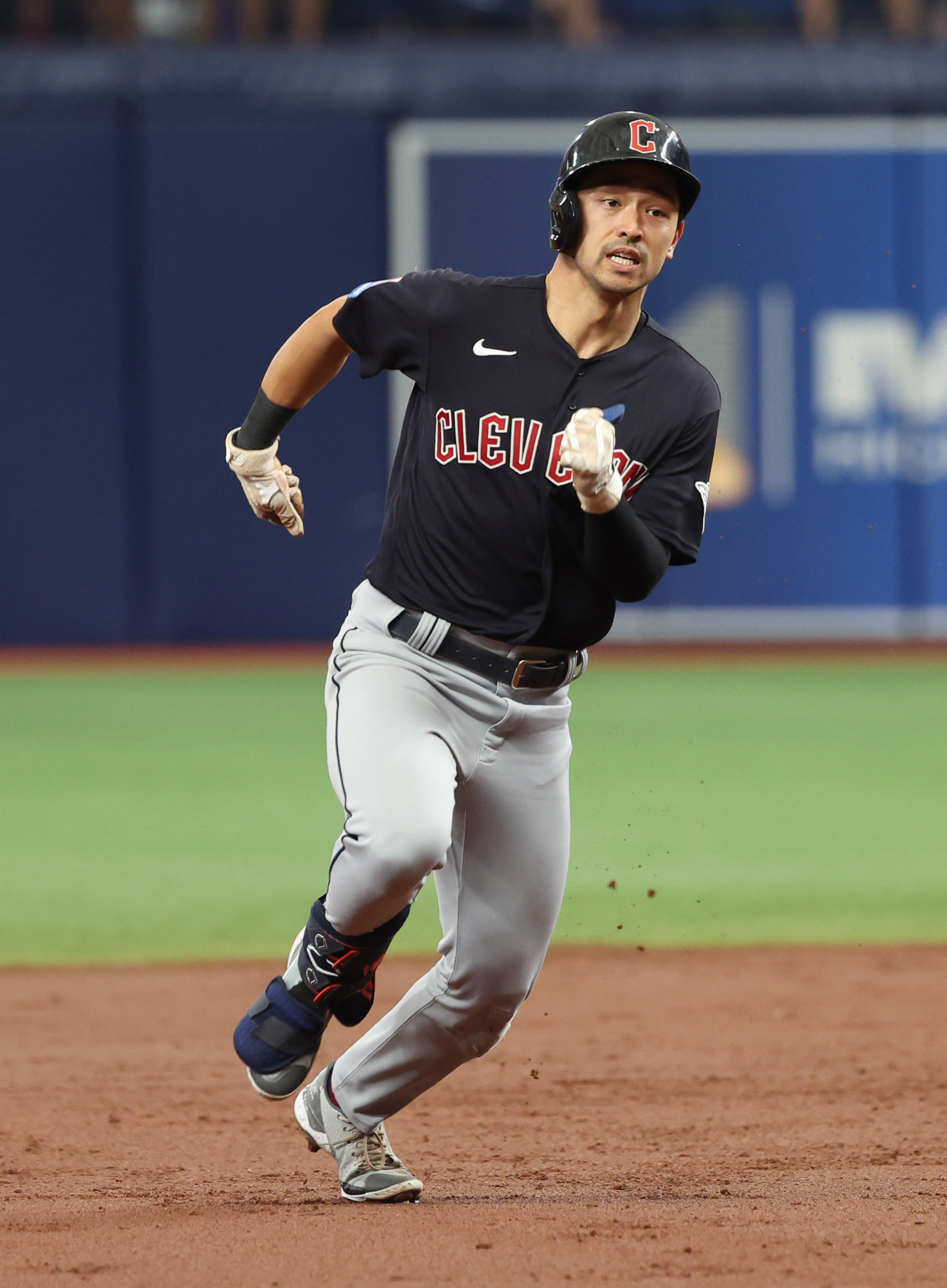 Tampa Bay Rays' Randy Arozarena is congratulated by teammates after scoring  the in the ninth inning of a baseball game against the Cleveland Indians,  Friday, July 23, 2021, in Cleveland. (AP Photo/Tony