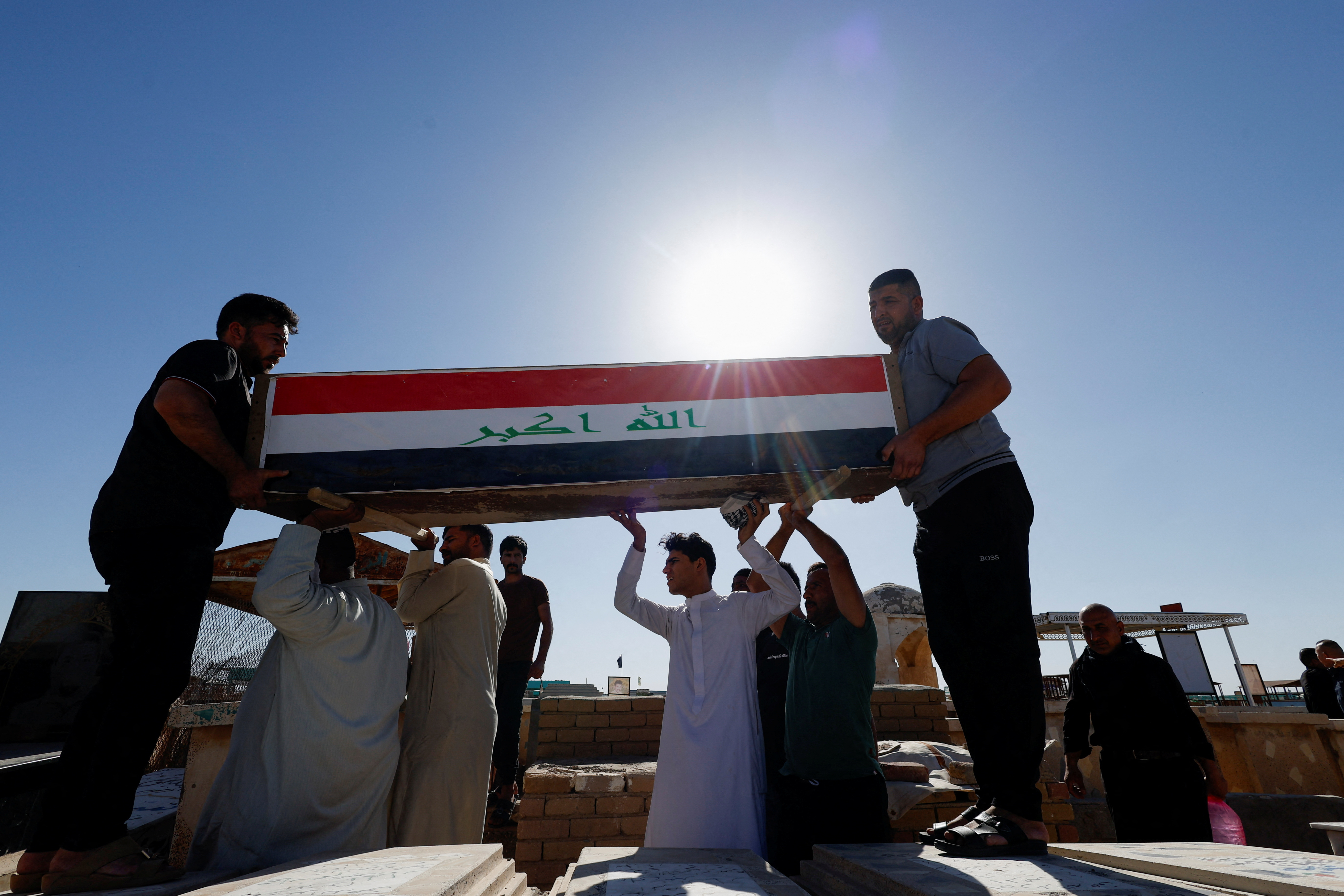Men carry coffin of an Iraqi soldier at the Wadi al-Salam cemetery, Arabic for 