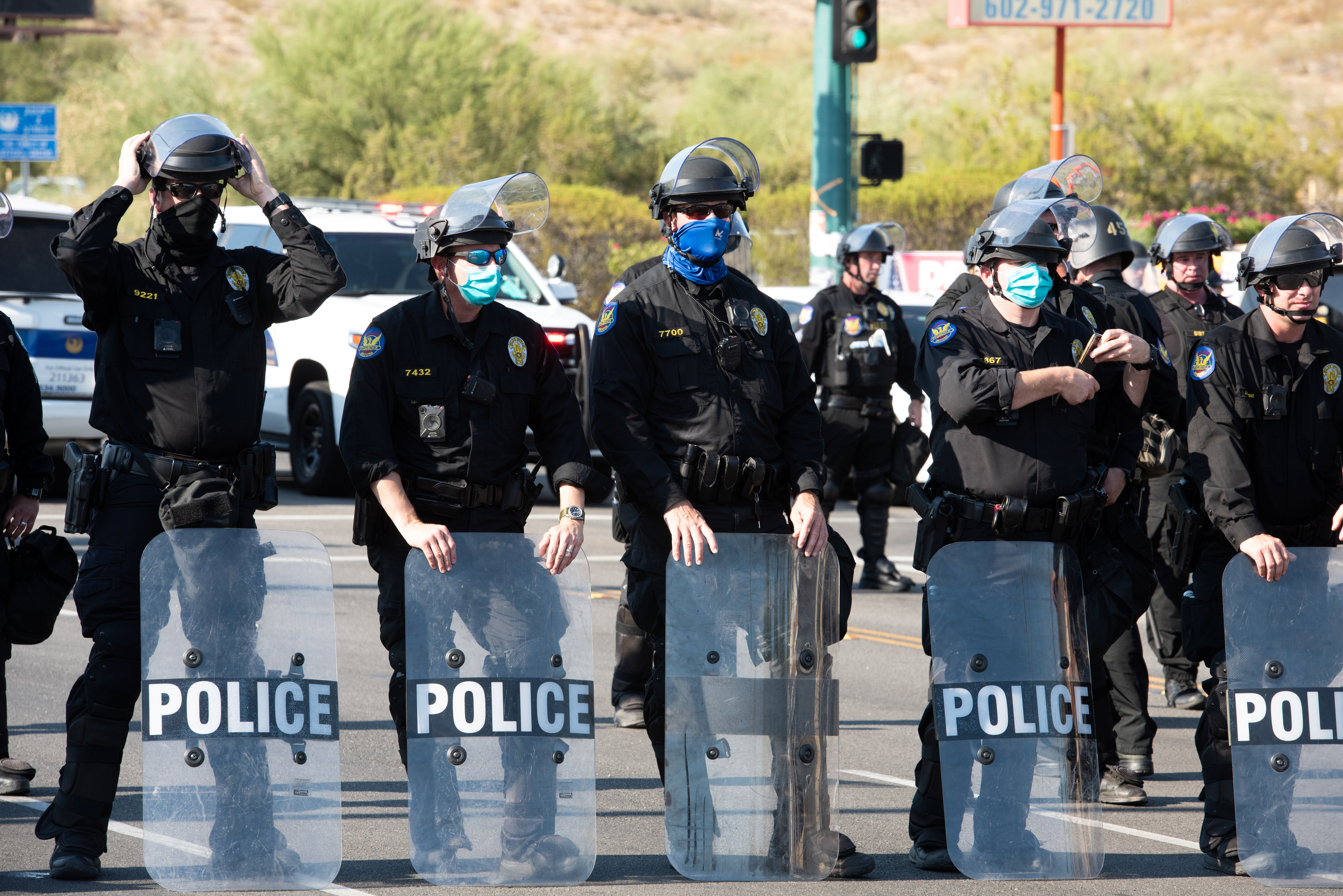 Police block protesters during a visit by U.S, President Donald Trump to the Dream City Church in Phoenix