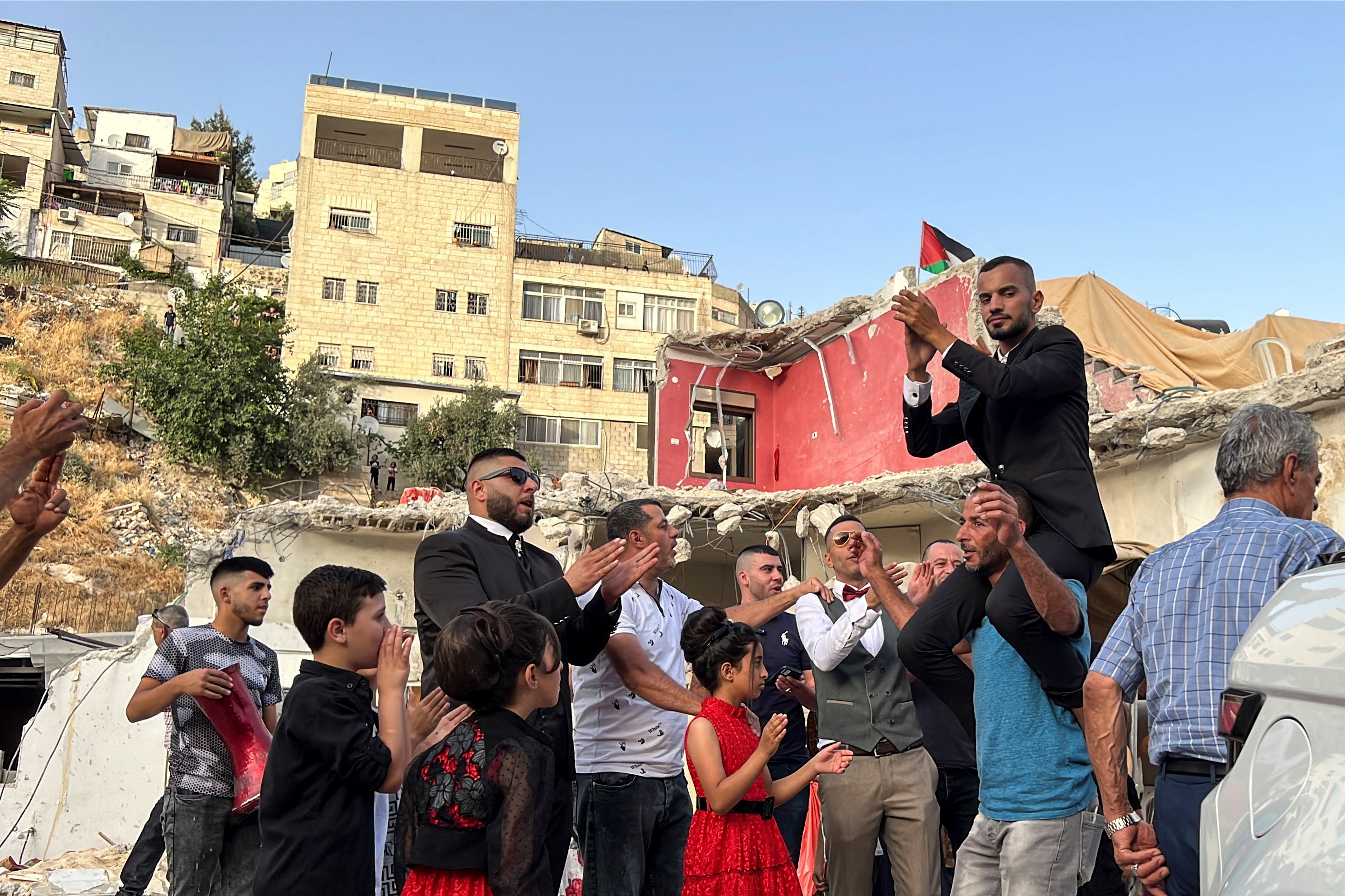 The groom of a Palestinian bride Rabeha Al-Rajabi, celebrates together with friends and family during a pre-wedding ceremony at Al-Rajabi house, that was partly demolished by Israel authority, in East Jerusalem