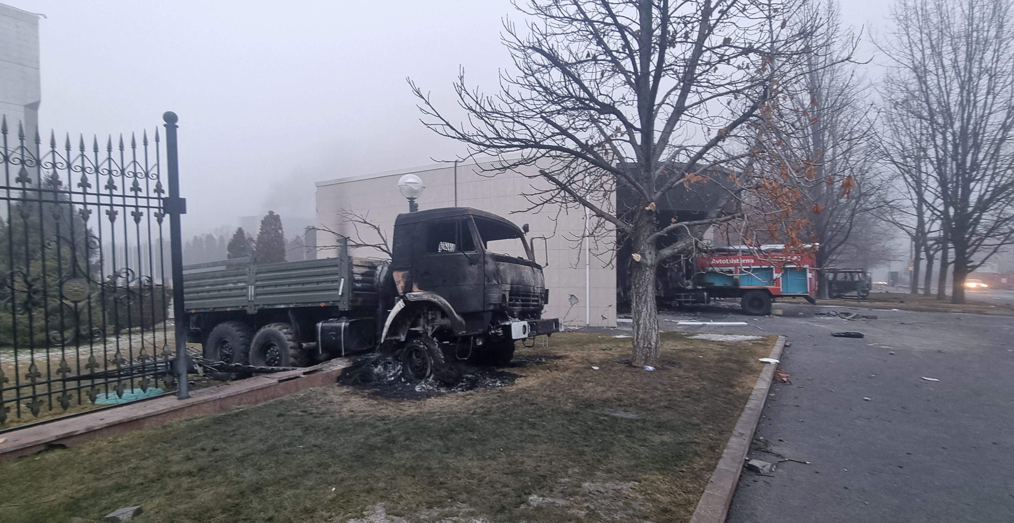 A burned truck is seen in front of the Presidential Residence in Almaty