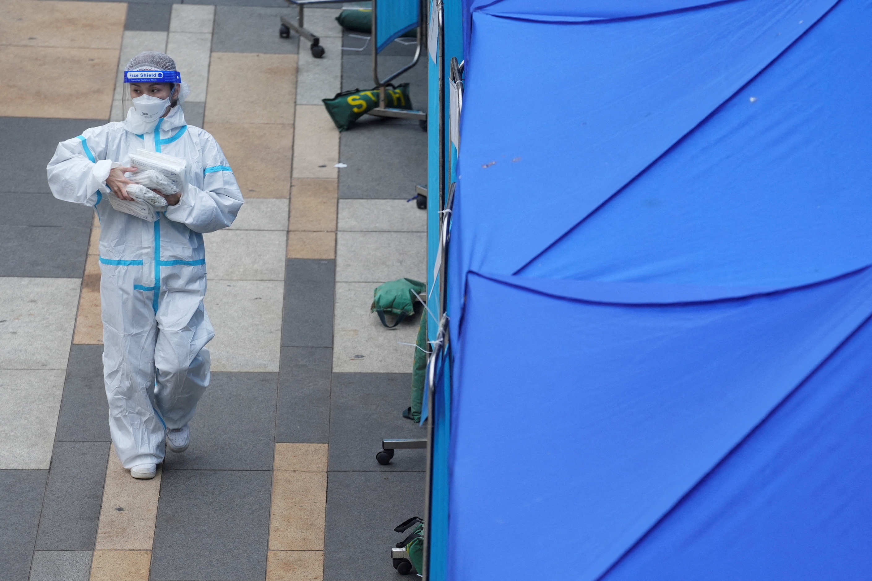A medical worker walks past a makeshift testing centre for the coronavirus disease (COVID-19) following the outbreak, outside a shopping mall at Sha Tin district, in Hong Kong, China, February 7, 2022. REUTERS/Lam Yik