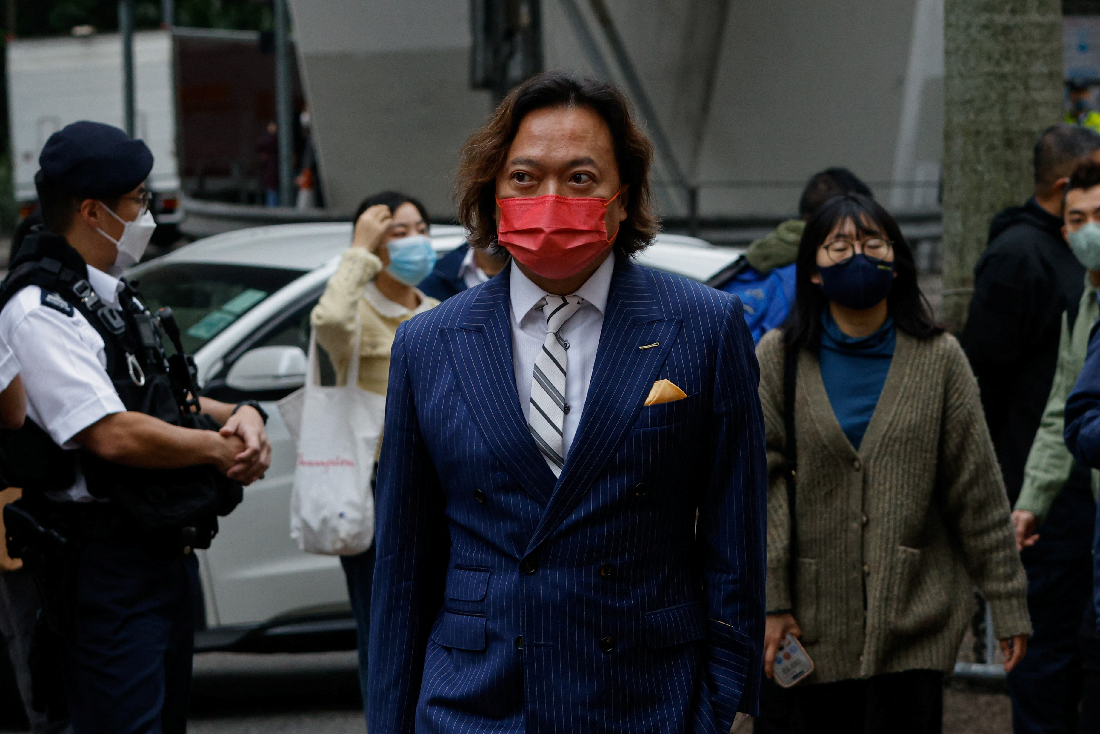 Lau Wai-Chung, one of the 47 pro-democracy activists charged with conspiracy to commit subversion under the national security law, arrives at the West Kowloon Magistrates' Courts building in Hong Kong