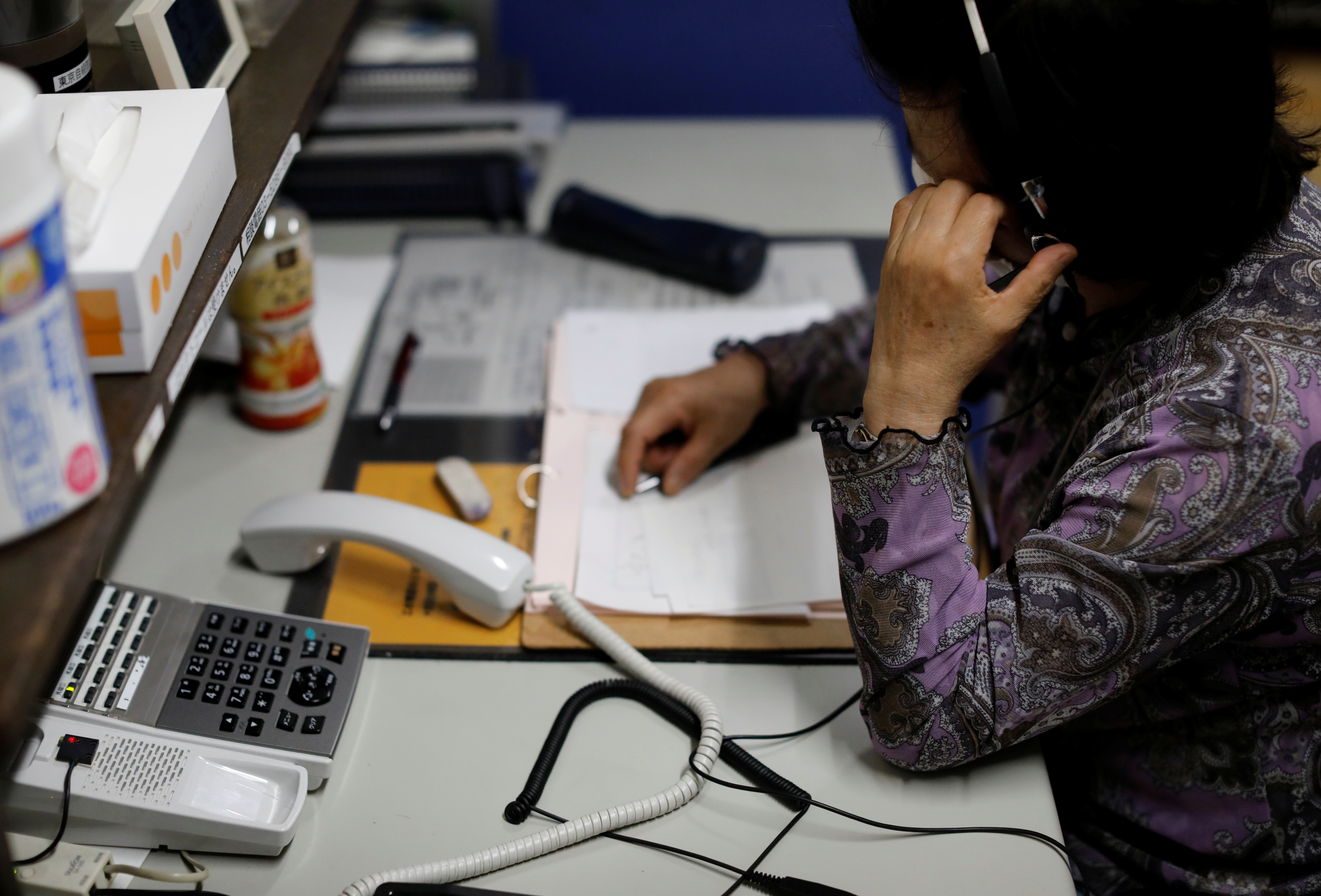 A volunteer responds an incoming call at the Tokyo Befrienders call center, a Tokyo's suicide hotline center, during the spread of the coronavirus disease (COVID-19), in Tokyo