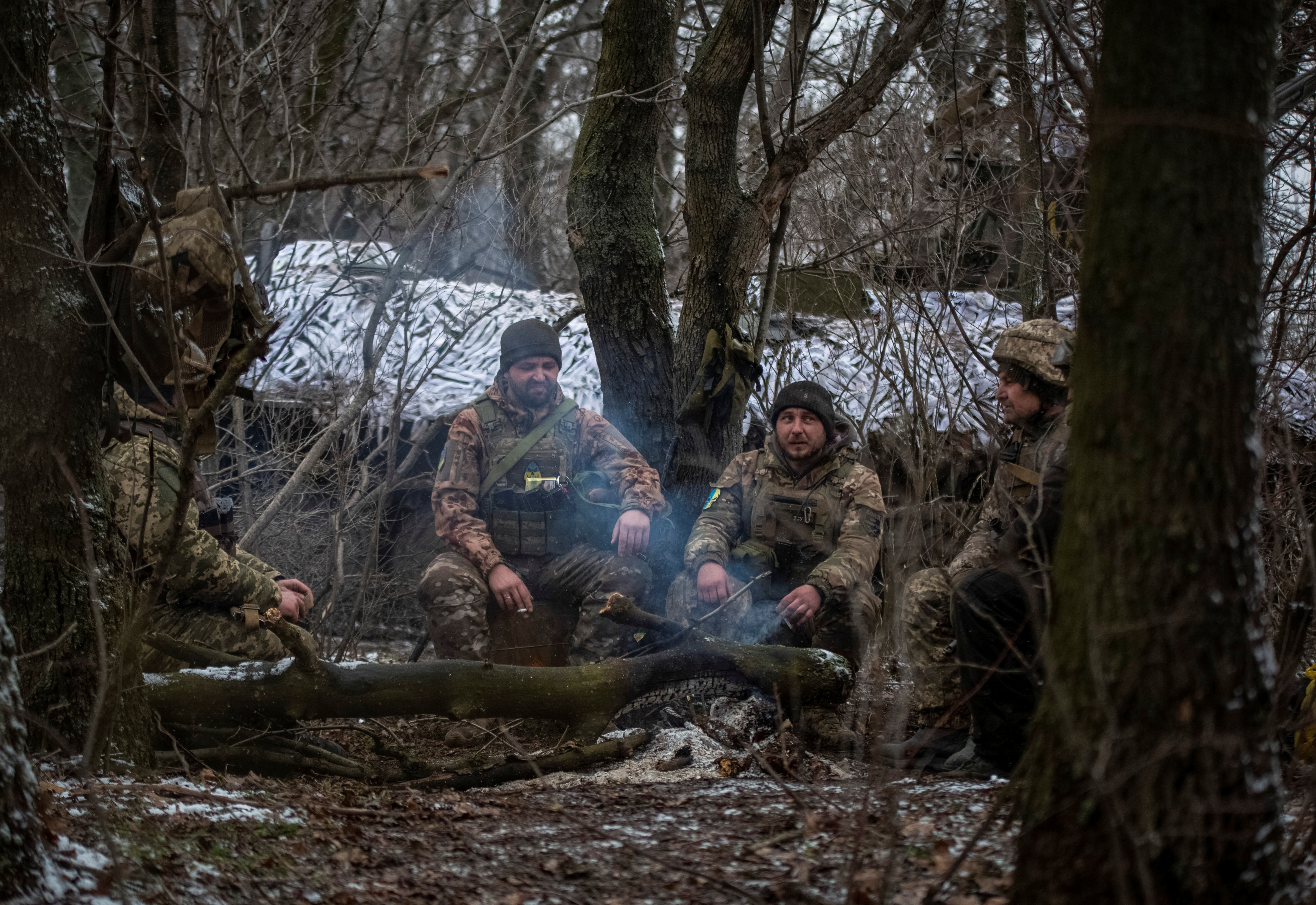 Ukrainian servicemen rest at their positions near a front line in Donetsk region