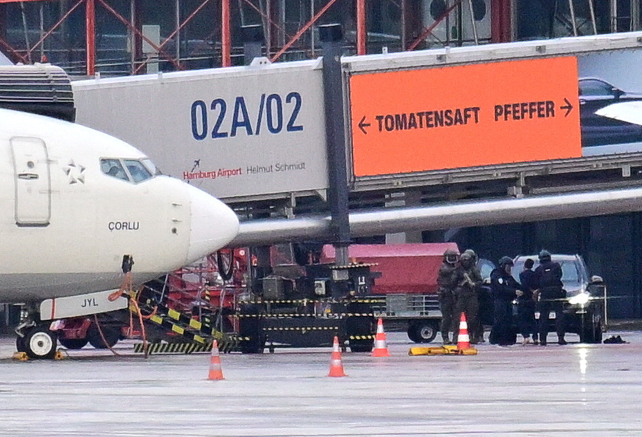 Police secure the area after a man drove through a barrier onto the grounds of the city's airport with a child in his car in Hamburg