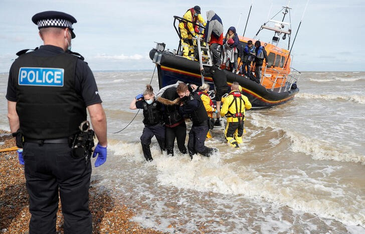 Rescued migrants arrive at the harbour in Dungeness