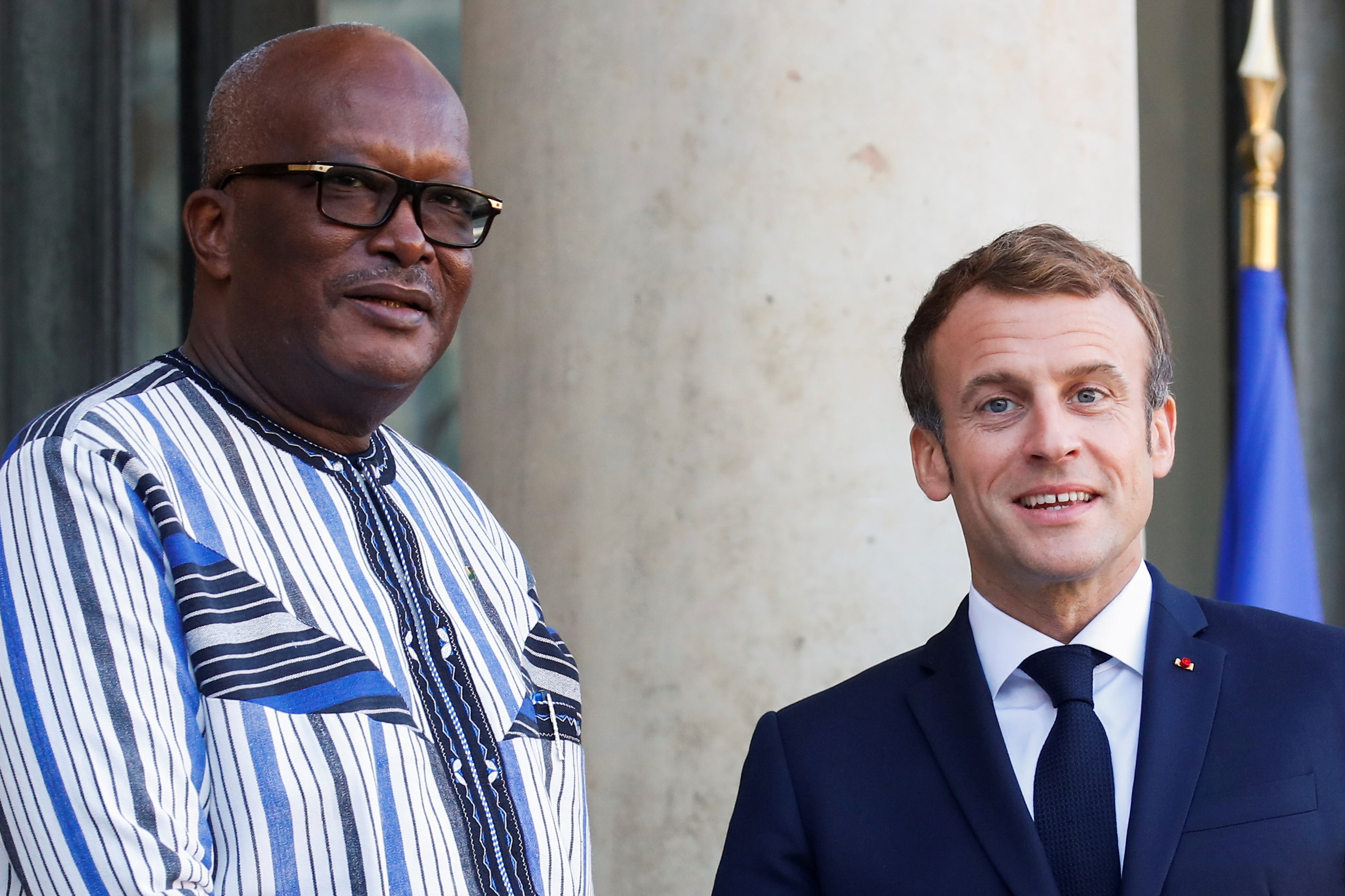 French President Emmanuel Macron welcomes Burkina Faso's President Roch Marc Christian Kabore before a meeting over security in the Sahel region at the Elysee Palace in Paris, France, November 12, 2021. REUTERS/Gonzalo Fuentes/File Photo