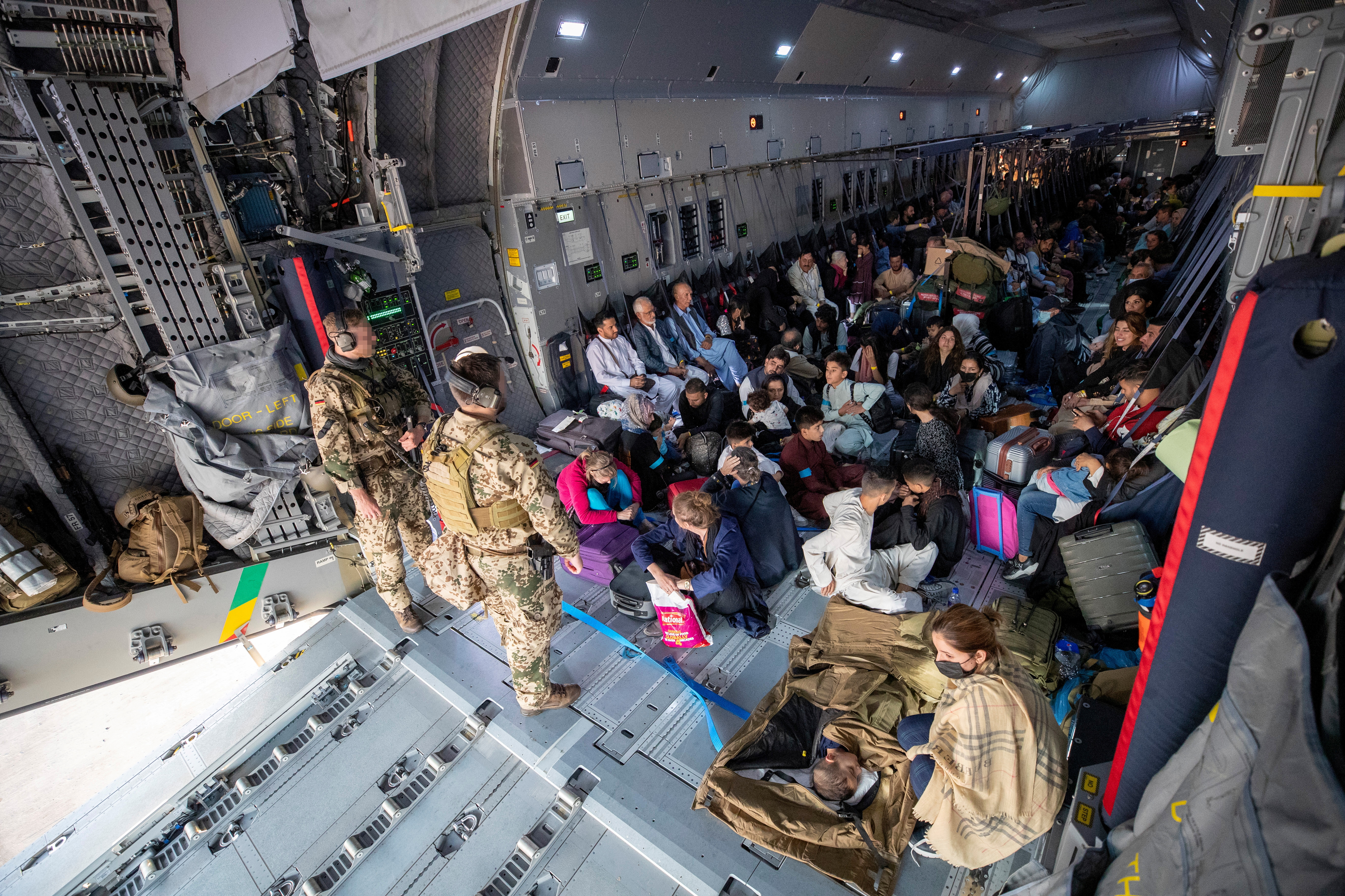 A handout photo obtained from Twitter via @Bw_Einsatz on August 17, 2021 shows evacuees from Afghanistan as they arrive in an Airbus A400 transport aircraft of the German Air Force Luftwaffe in Tashkent, Uzbekistan.      Marc Tessensohn/Twitter @Bw_Einsatz/Handout via REUTERS ATTENTION EDITORS - THIS IMAGE HAS BEEN SUPPLIED BY A THIRD PARTY      NO RESALES. NO ARCHIVES