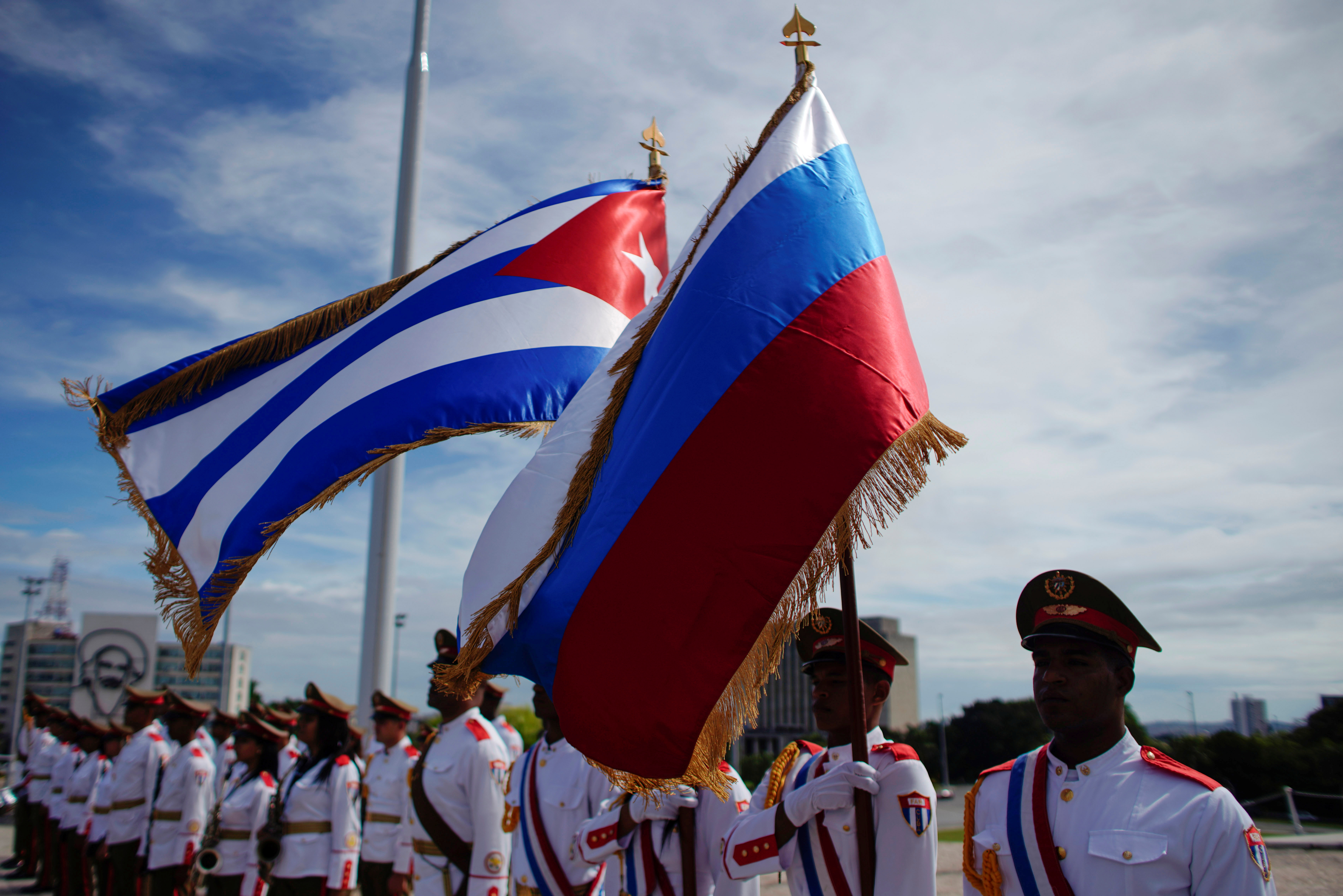 Honor guards hold a Russian and a Cuban flag during a wreath-laying ceremony with Russia's Prime Minister Dmitry Medvedev at the Jose Marti monument in Havana