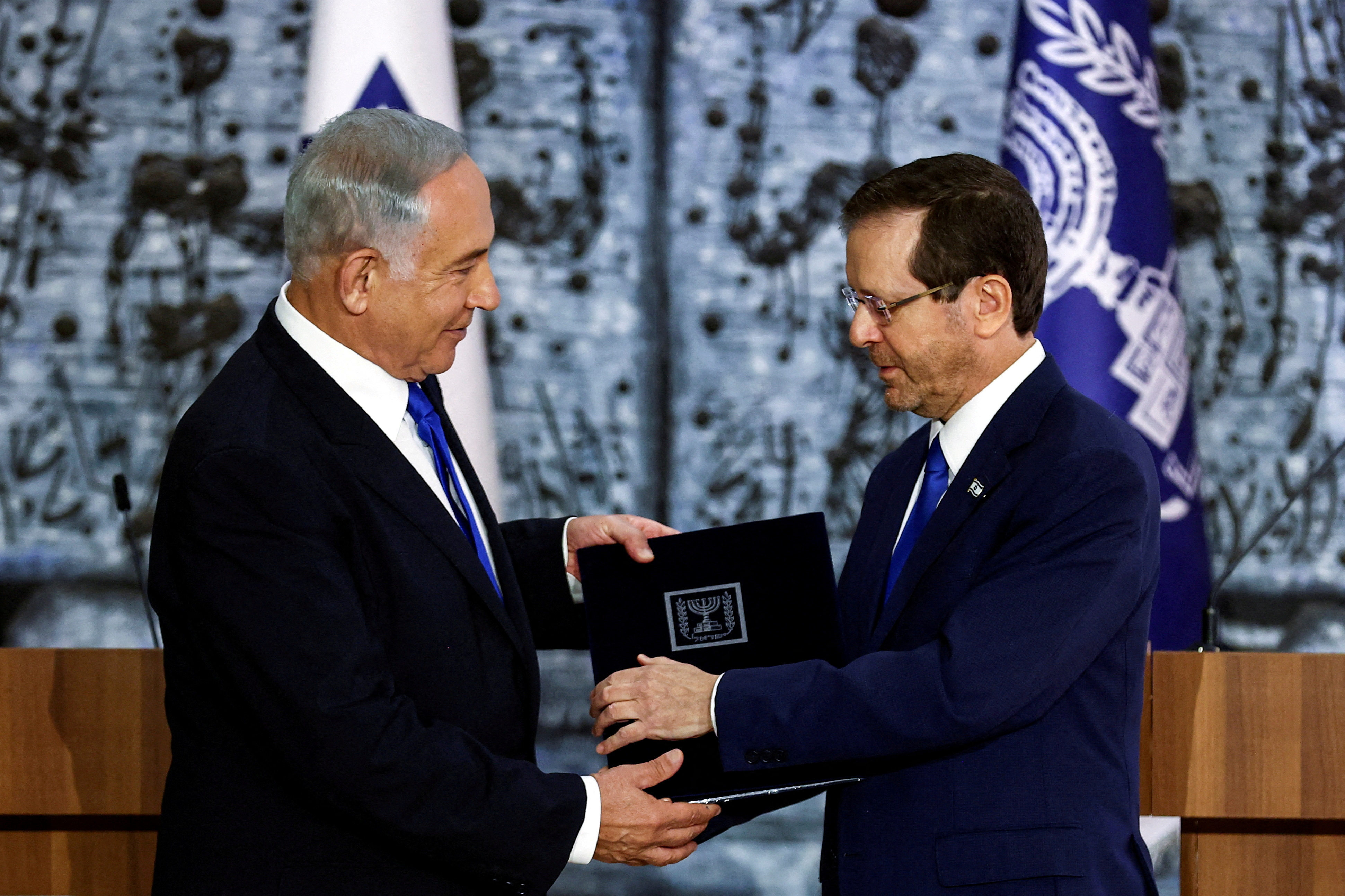 Israel President Isaac Herzog hands Benjamin Netanyahu the mandate to form a new government following the election victory of the former premier's right-wing alliance