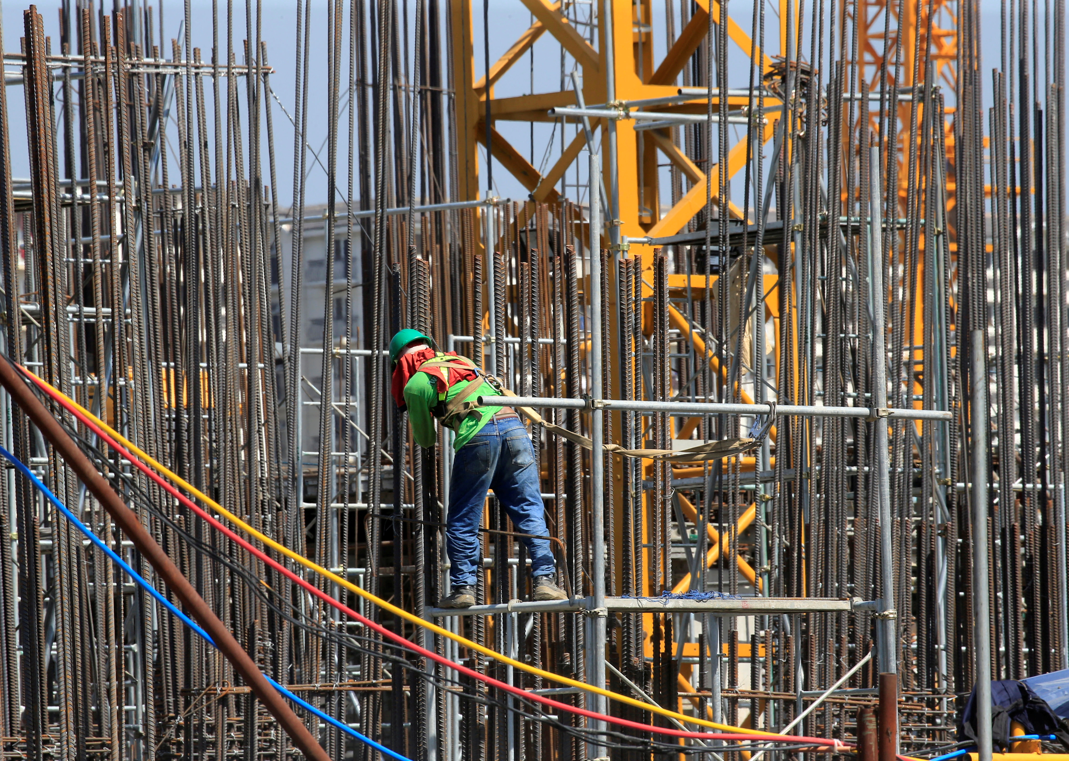 A worker installs steel rods at a construction site in Paranaque city, metro Manila