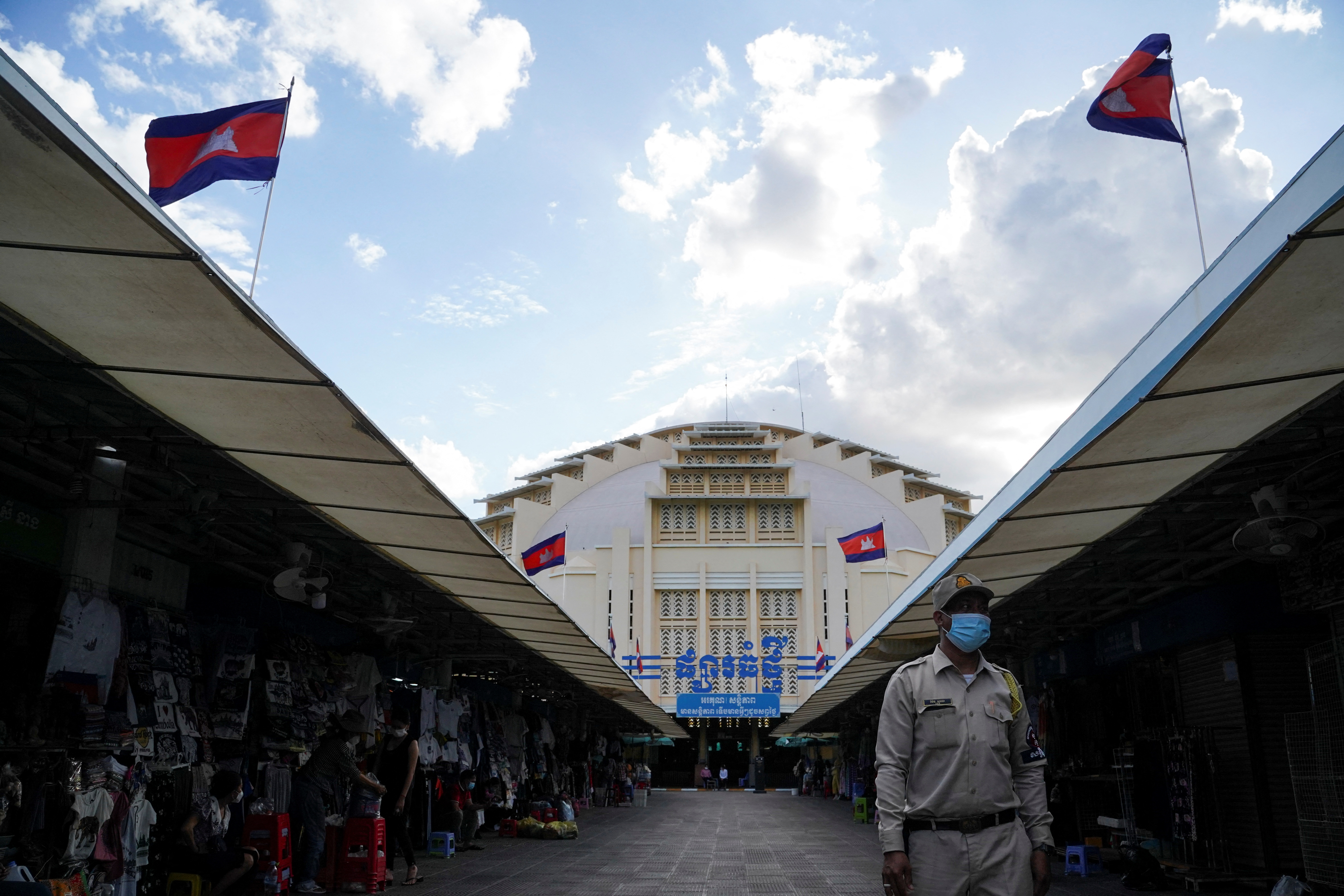 A guard walks past empty stalls at Central Market in Phnom Penh