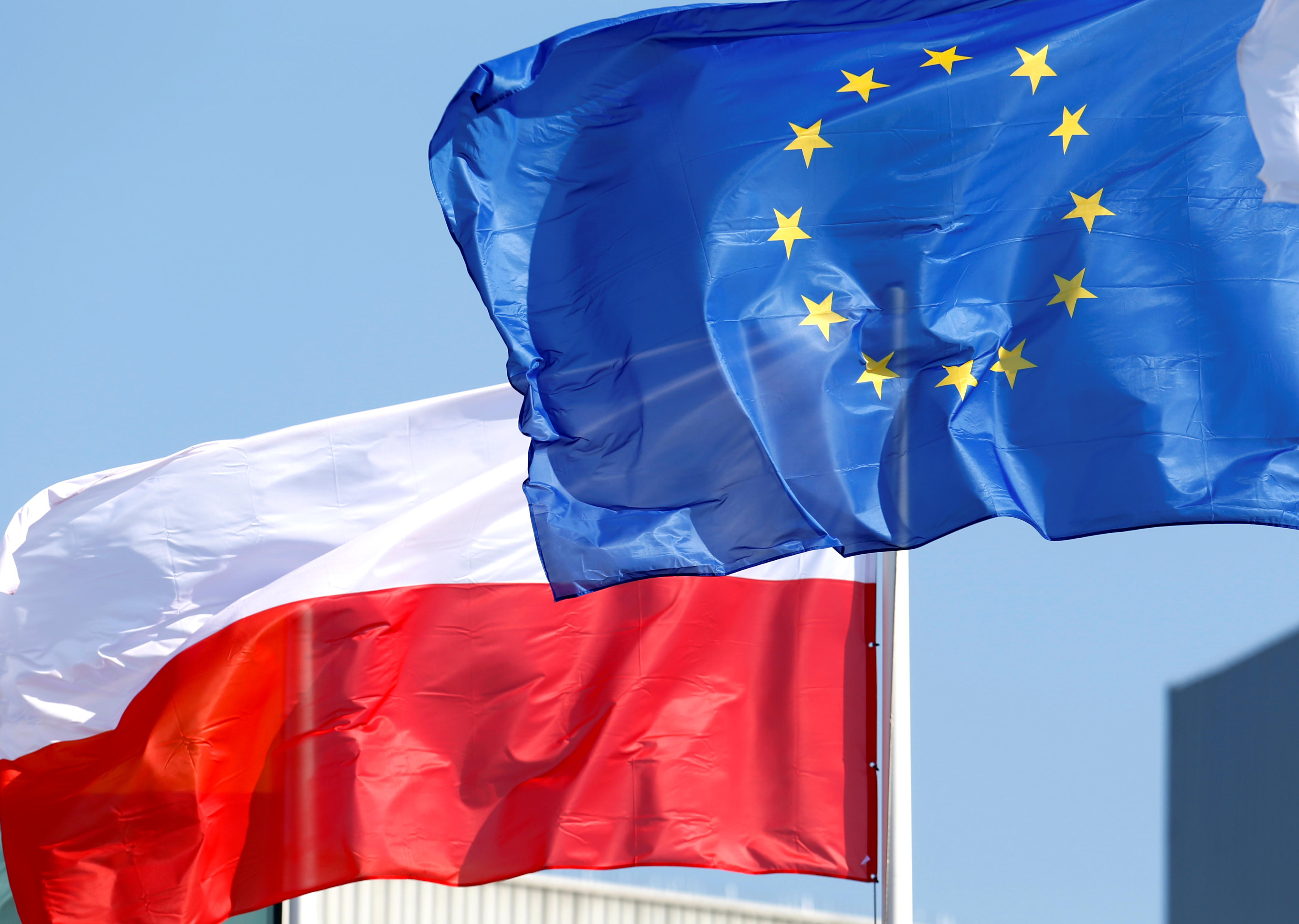 European Union and Poland's flags flutter at the Orlen refinery in Mazeikiai, Lithuania April 5, 2019. REUTERS/Ints Kalnins